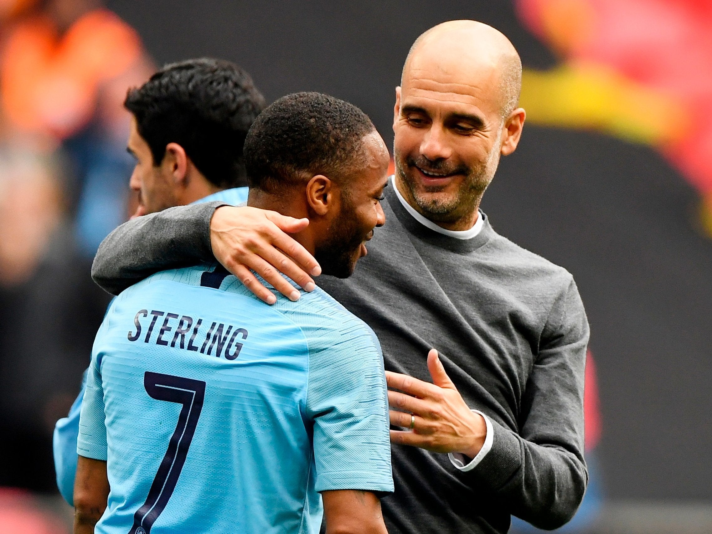 Raheem Sterling is congratulated by Guardiola