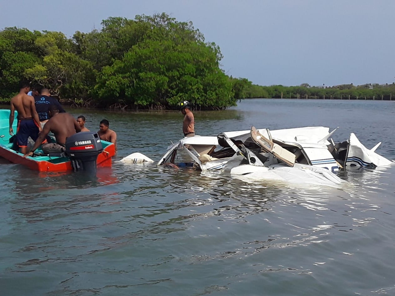 Honduras firefighter at the scene where a private plane carrying foreign tourists crashed into the seat at the Isla Bonita Area, in Roatan, Honduras, on 18 May 2019.