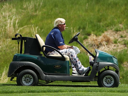 John Daly smokes a Marlboro Red on his route around Bethpage Black