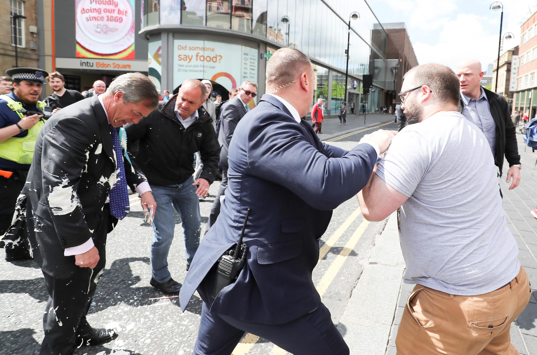 Brexit Party leader Nigel gestures after being hit with a milkshake while arriving for a Brexit Party campaign event in Newcastle