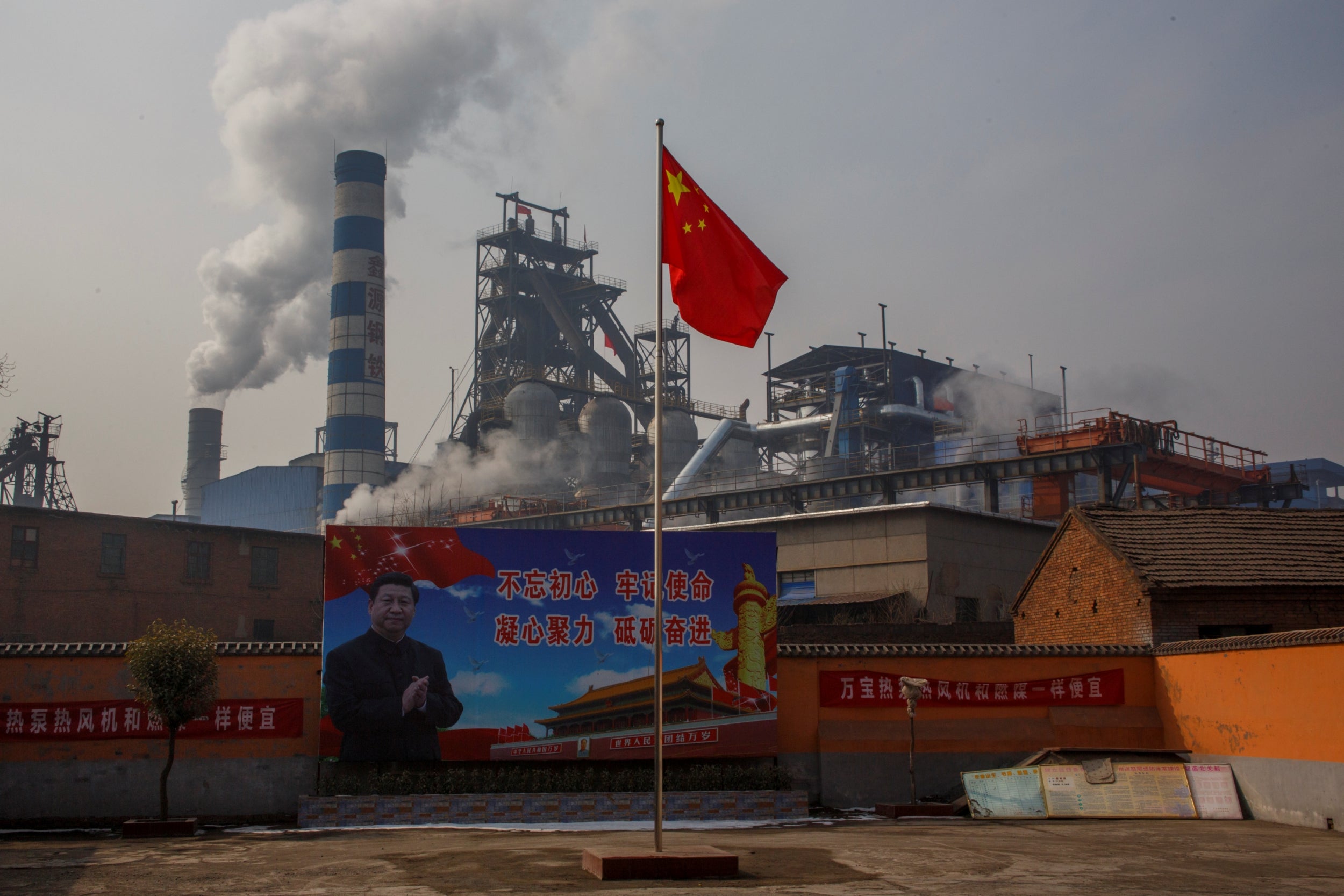 A poster showing Chinese President Xi Jinping is seen in front of the Xinyuan Steel plant in Anyang (Reuters)