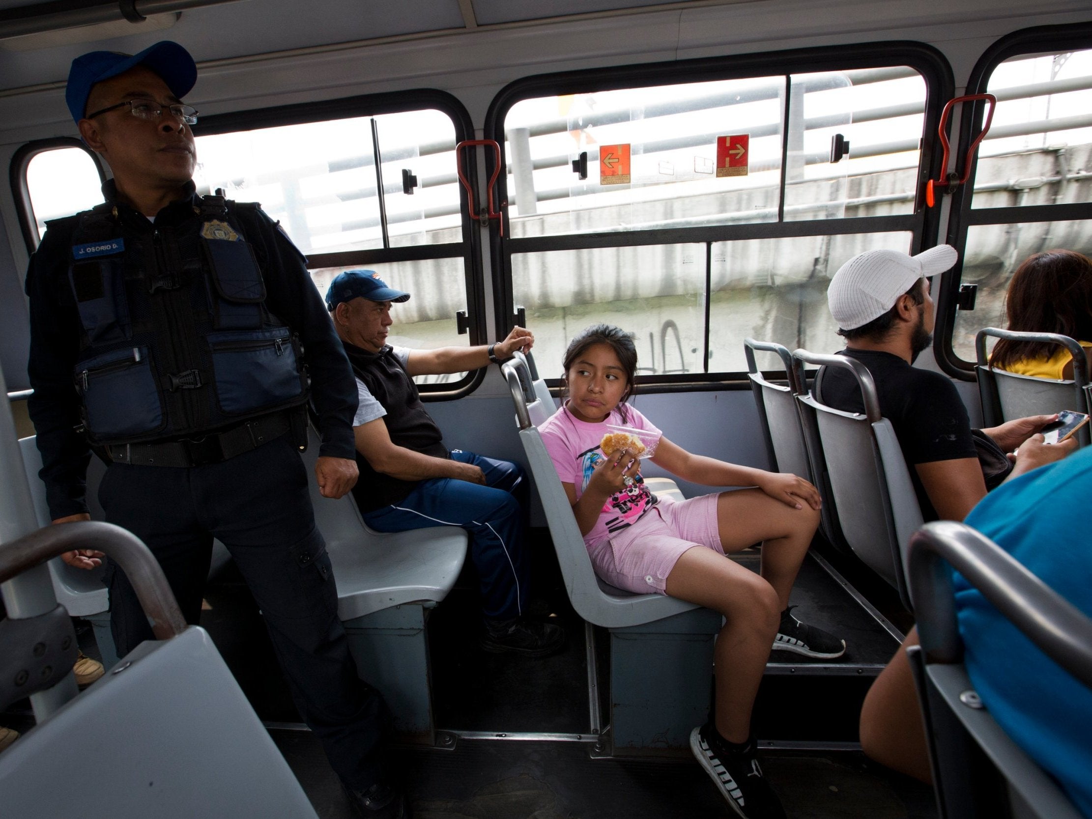 A police officer stands at the back of a bus in the Iztapalapa borough of Mexico City.