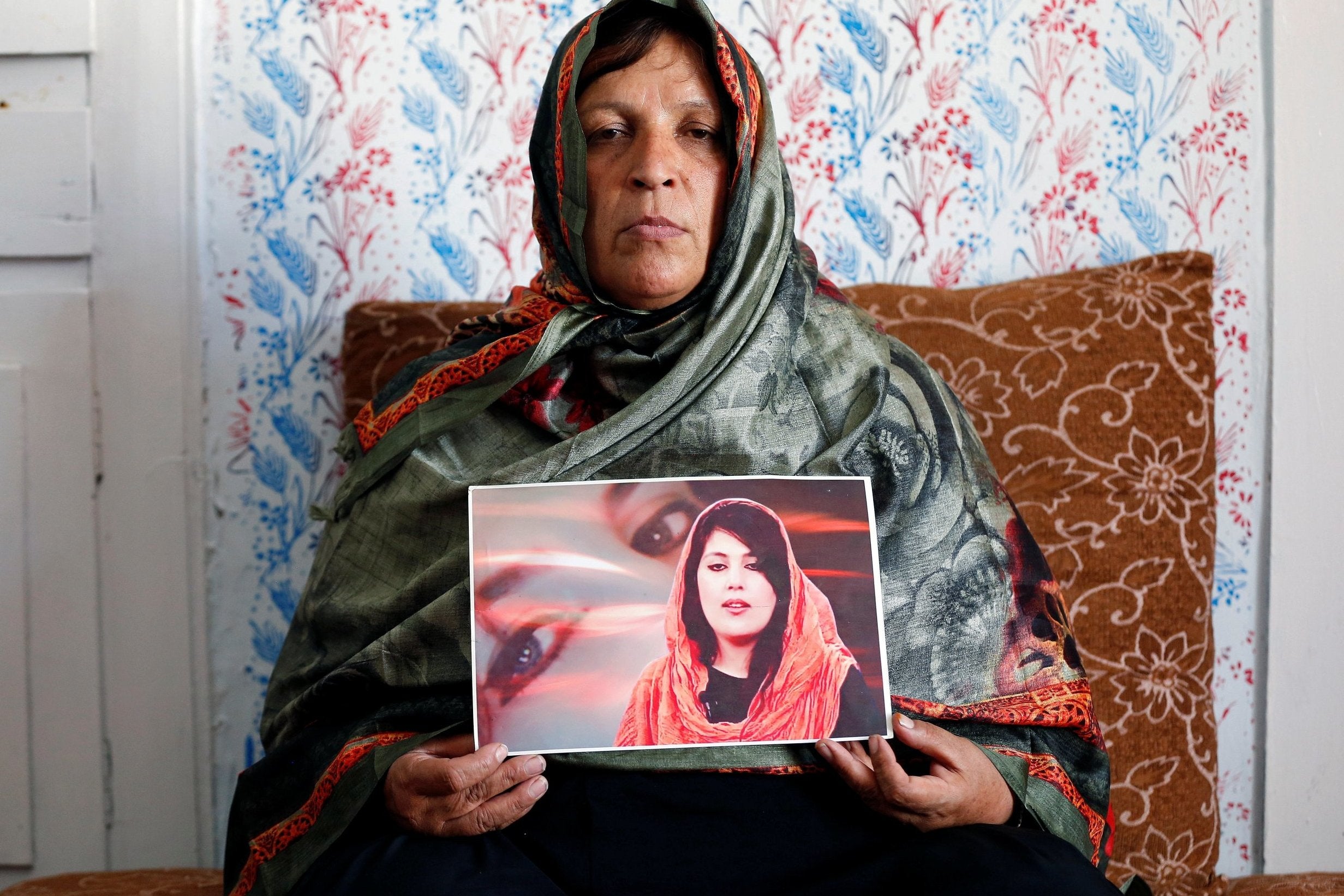 Anisa Mangal holds a photo of her daughter