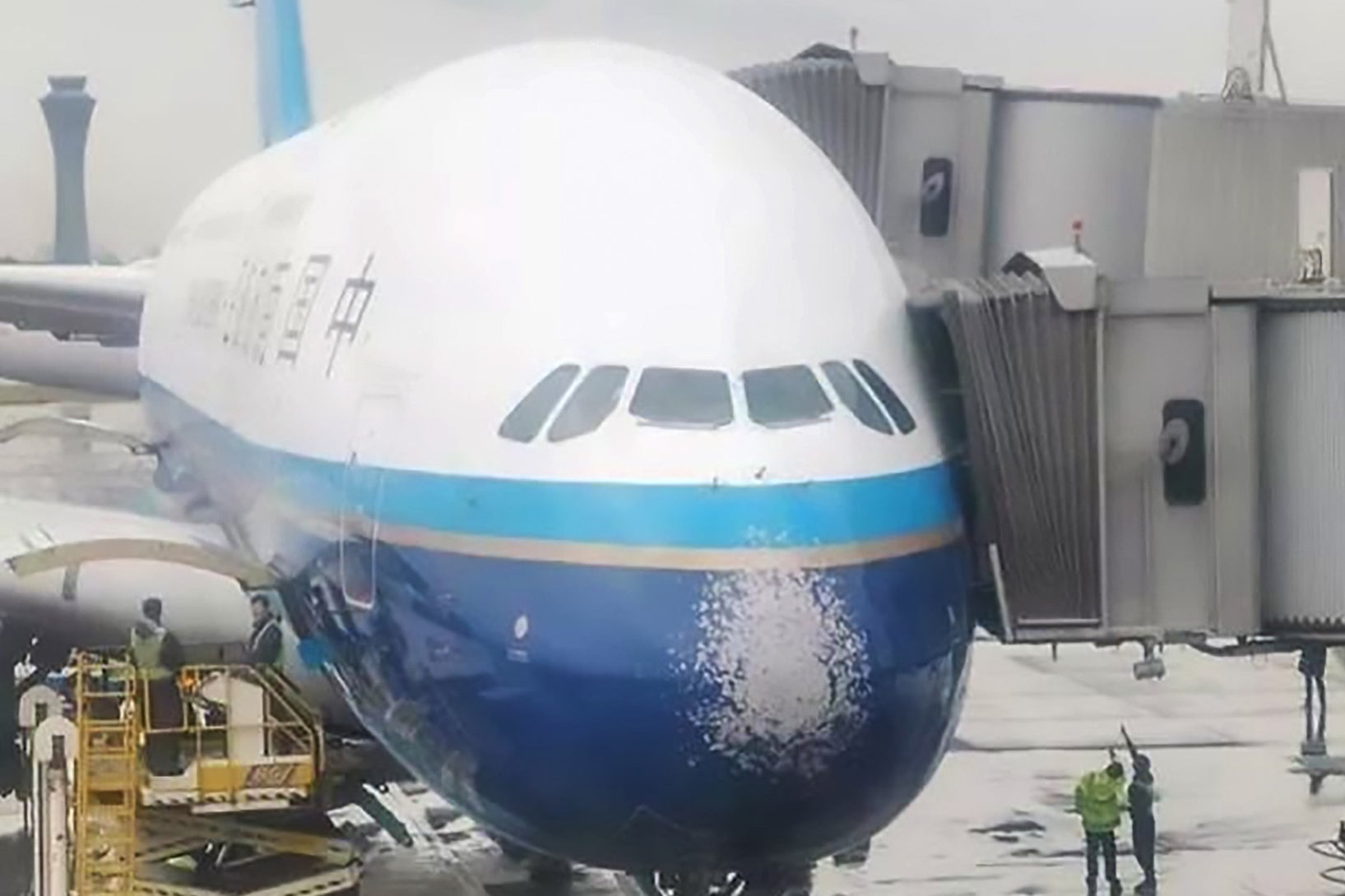 The chipped paintwork on the nose of the aircraft can also be seen