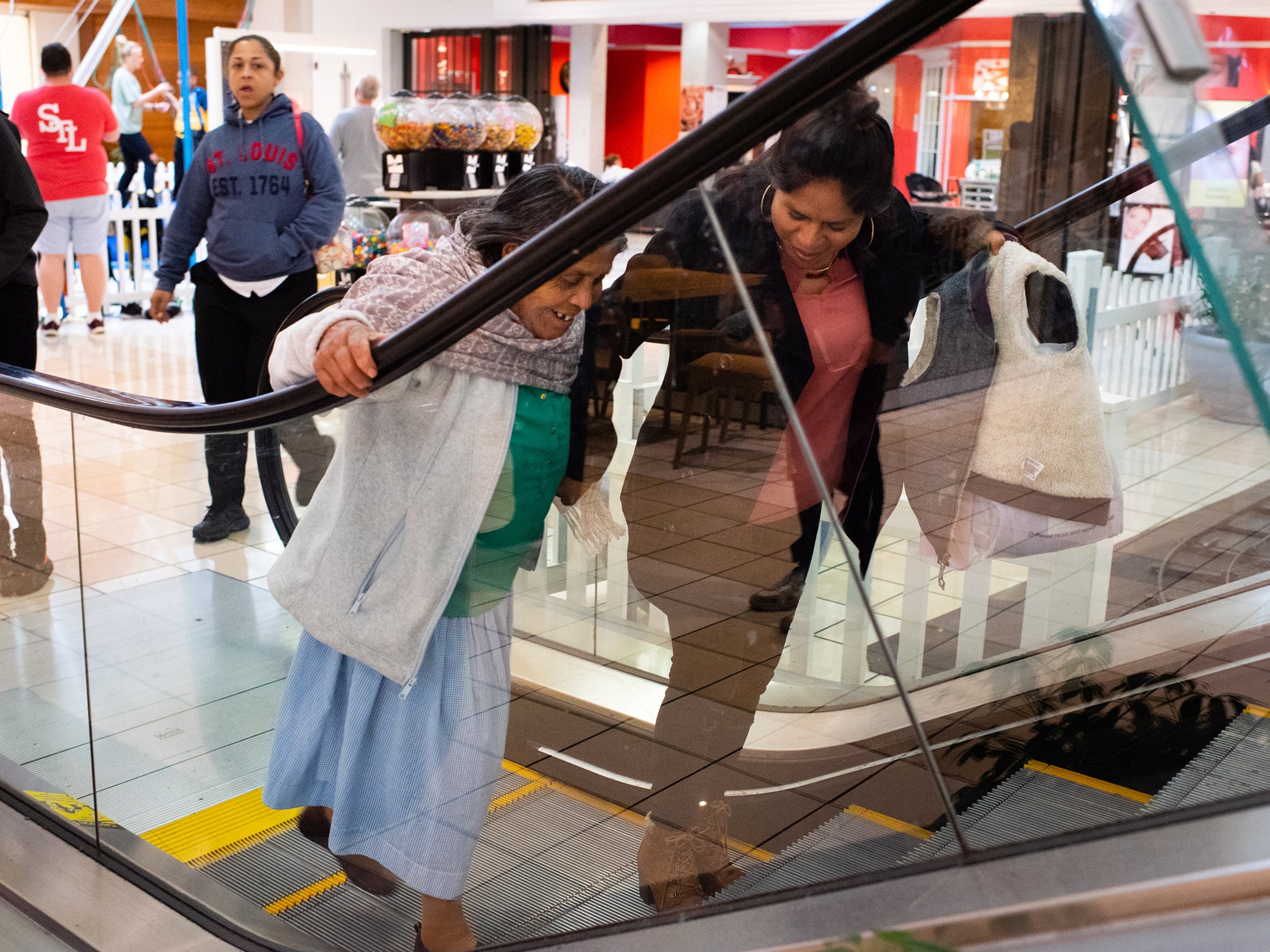 Romero Leon takes her first step onto an escalator at a shopping mall in Fairview Heights, Illinois with her daughter