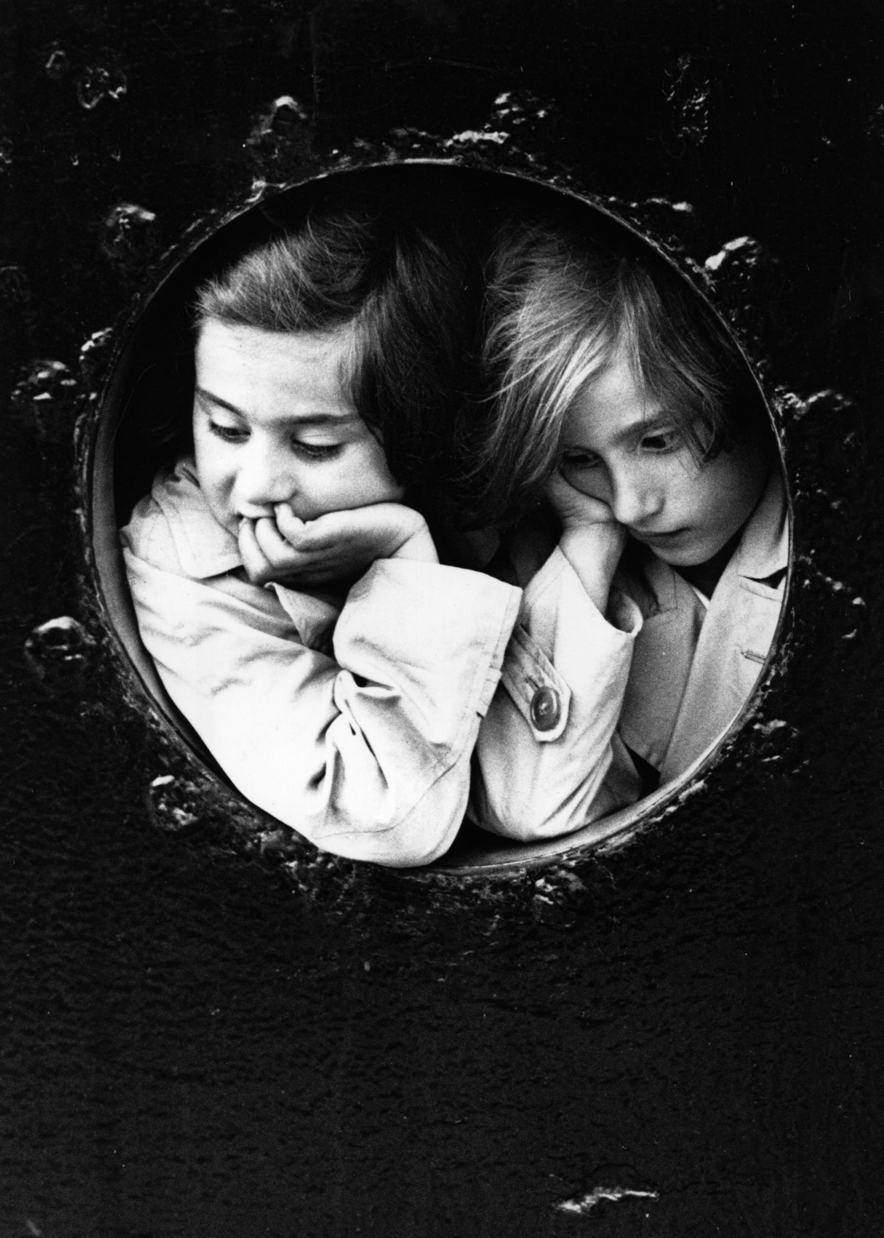 Two German Jewish children look out at Antwerp from a porthole on the MS St Louis in June 1939