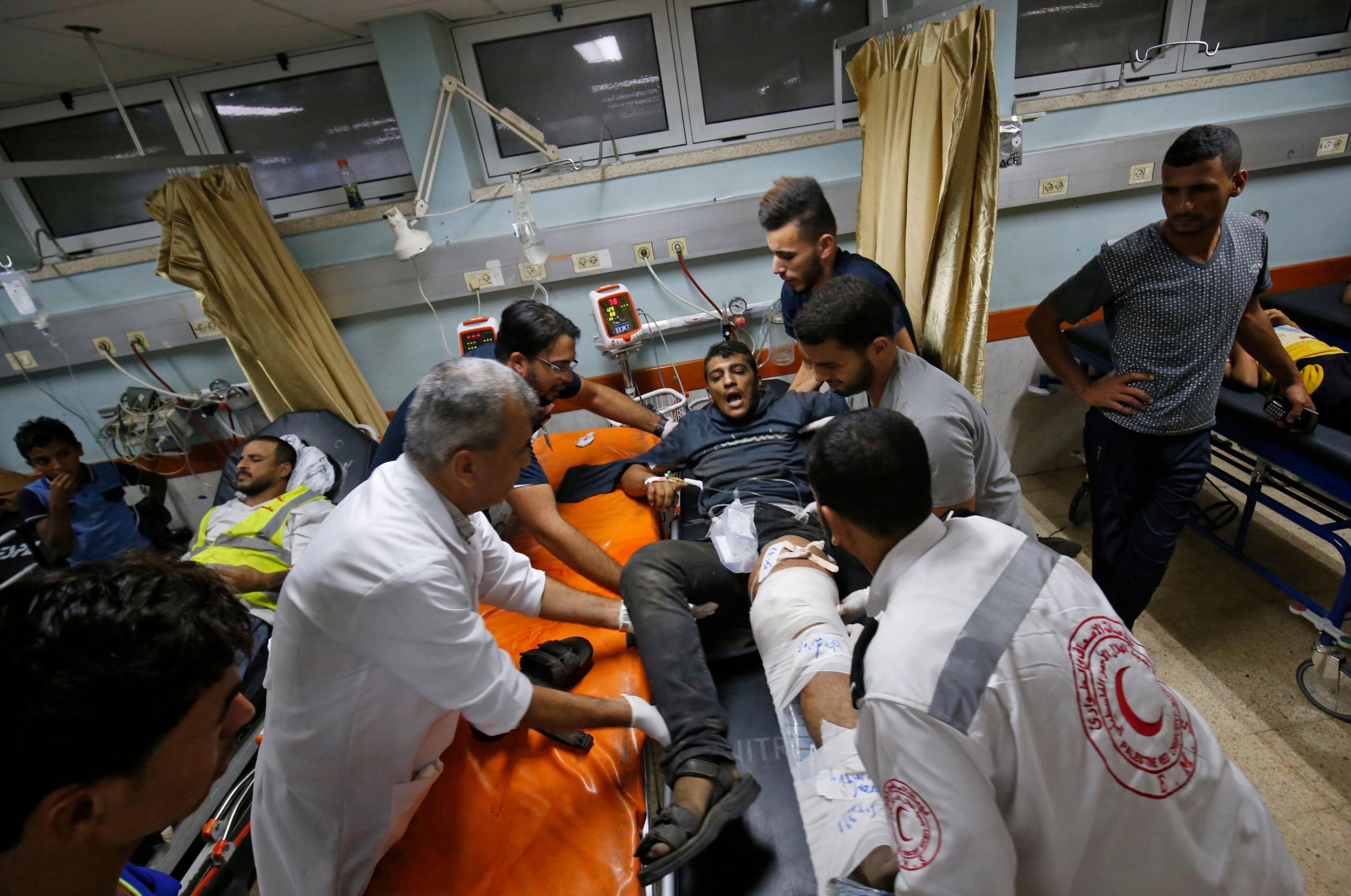 Palestinian paramedics tend to a youth who was injured during clashes by the border with Israel, at a hospital in Khan Yunis in the southern Gaza Strip