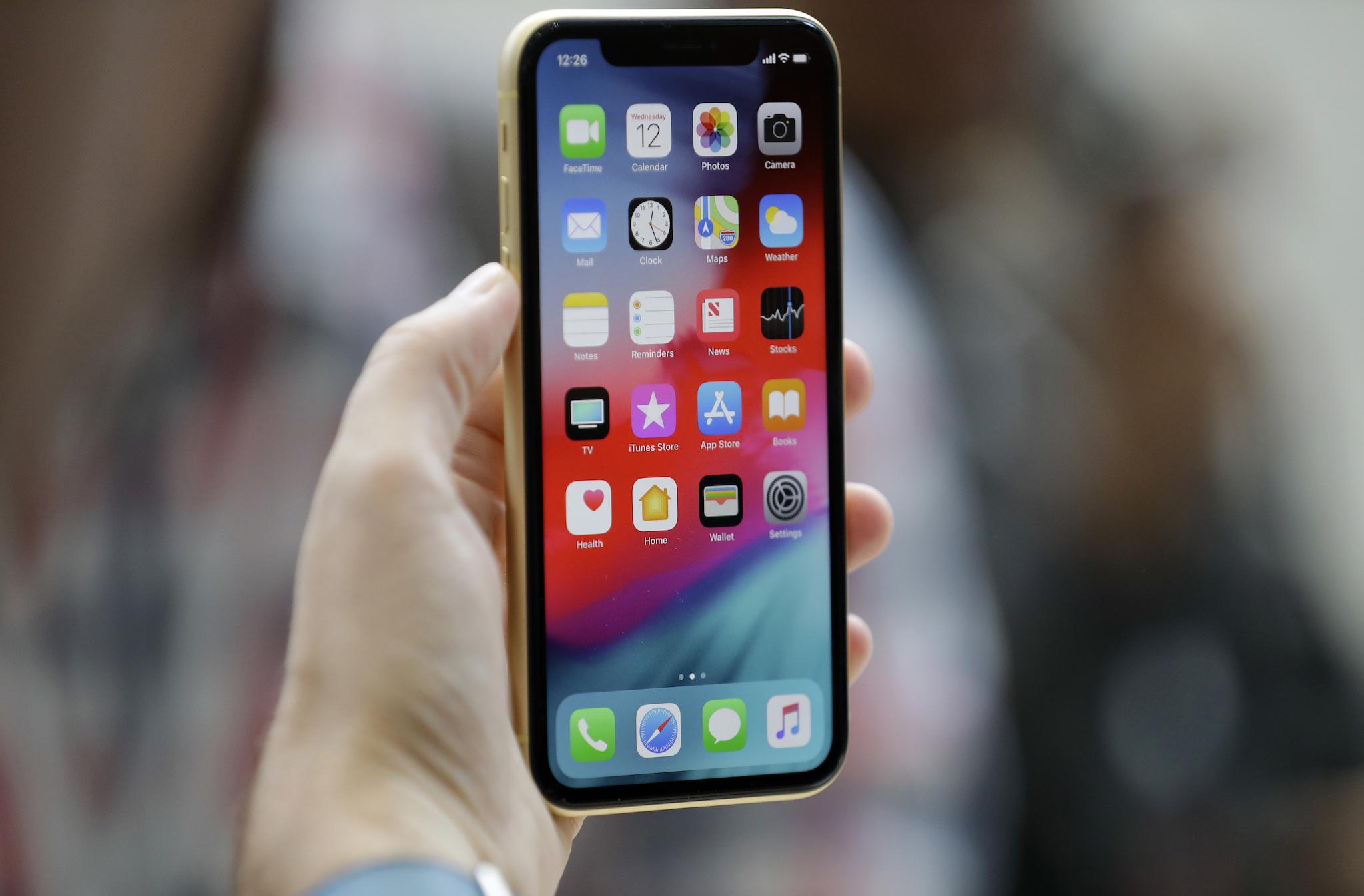 This Sept. 12, 2018, file photo shows an Apple iPhone XR on display at the Steve Jobs Theater after an event to announce new products, in Cupertino, California