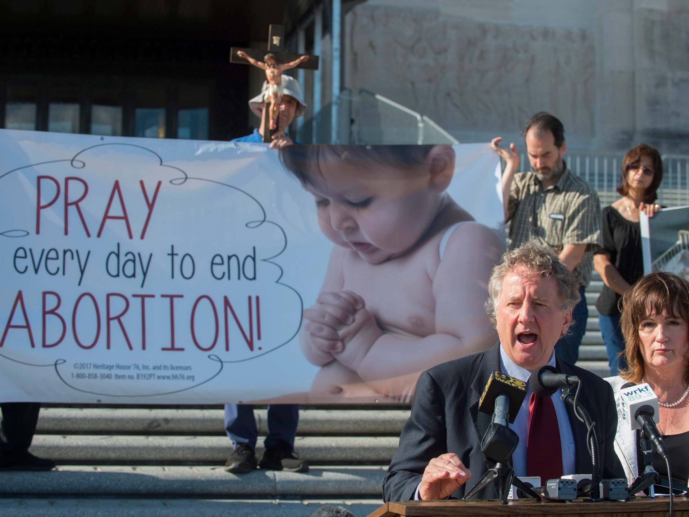 Louisiana senator John Milkovich (left) and Republican Valarie Hodges speak after the Louisiana House passed Mr Milkovich's 'fetal heartbeat' bill that would ban abortions at about six weeks of pregnancy, if upheld by the courts.