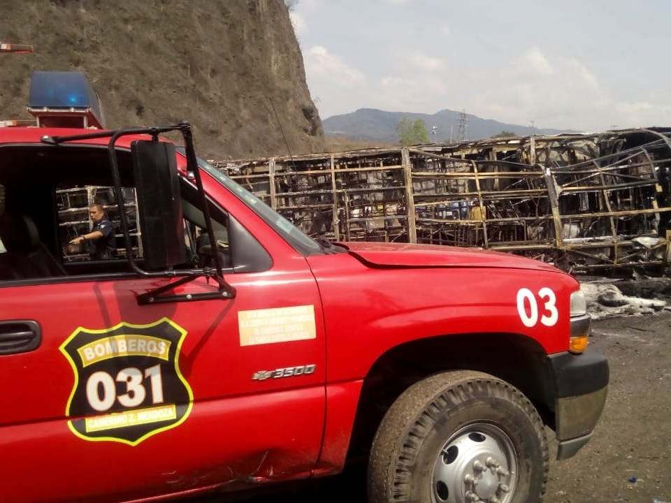 Firemen work in the recovery efforts of a deadly road accident between a bus and a semi-trailer, on a mountain road in Veracruz state, Mexico, Wednesday 29 May 2019.