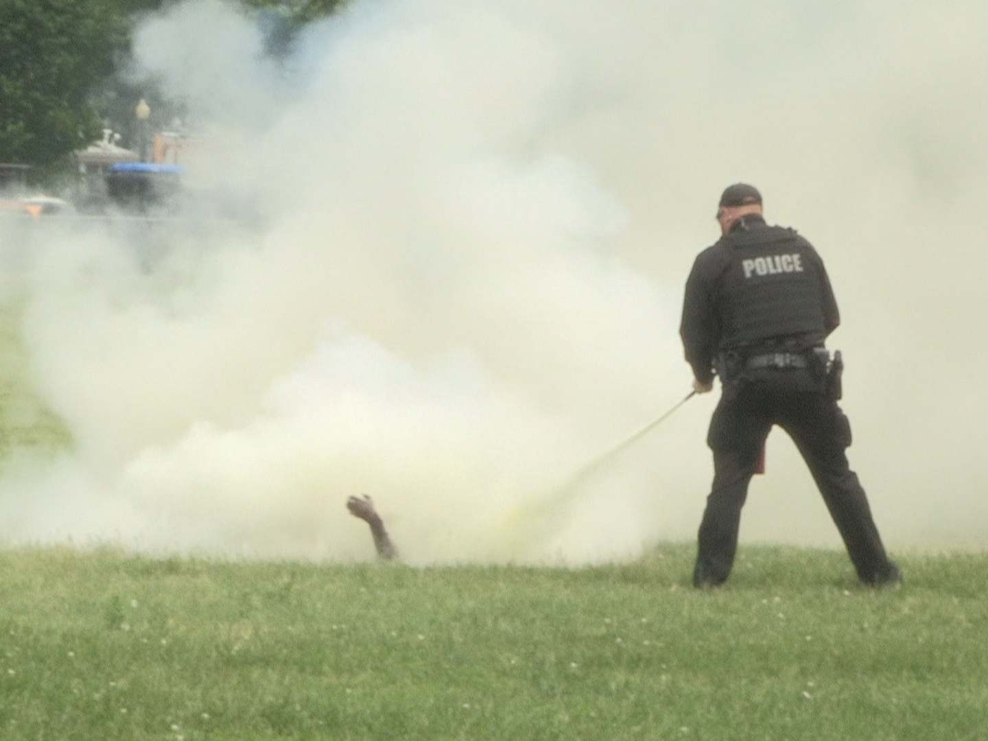 A still from a video shows a police officer extinguishing a man who set himself on fire on the Ellipse across from the White House, in Washington, DC, USA, 29 May 2019.