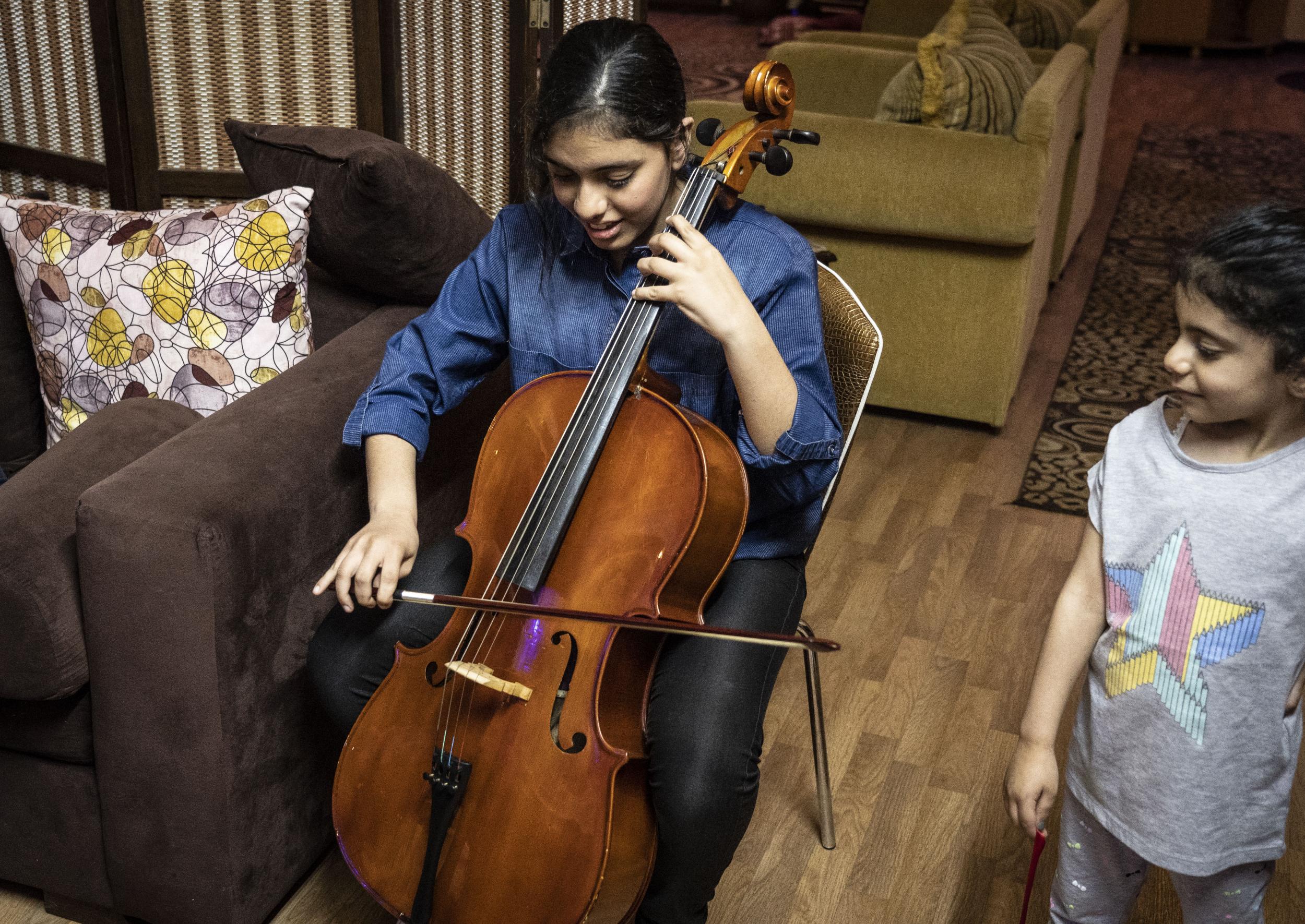 In tune: Nawar plays her cello during the Skype meeting