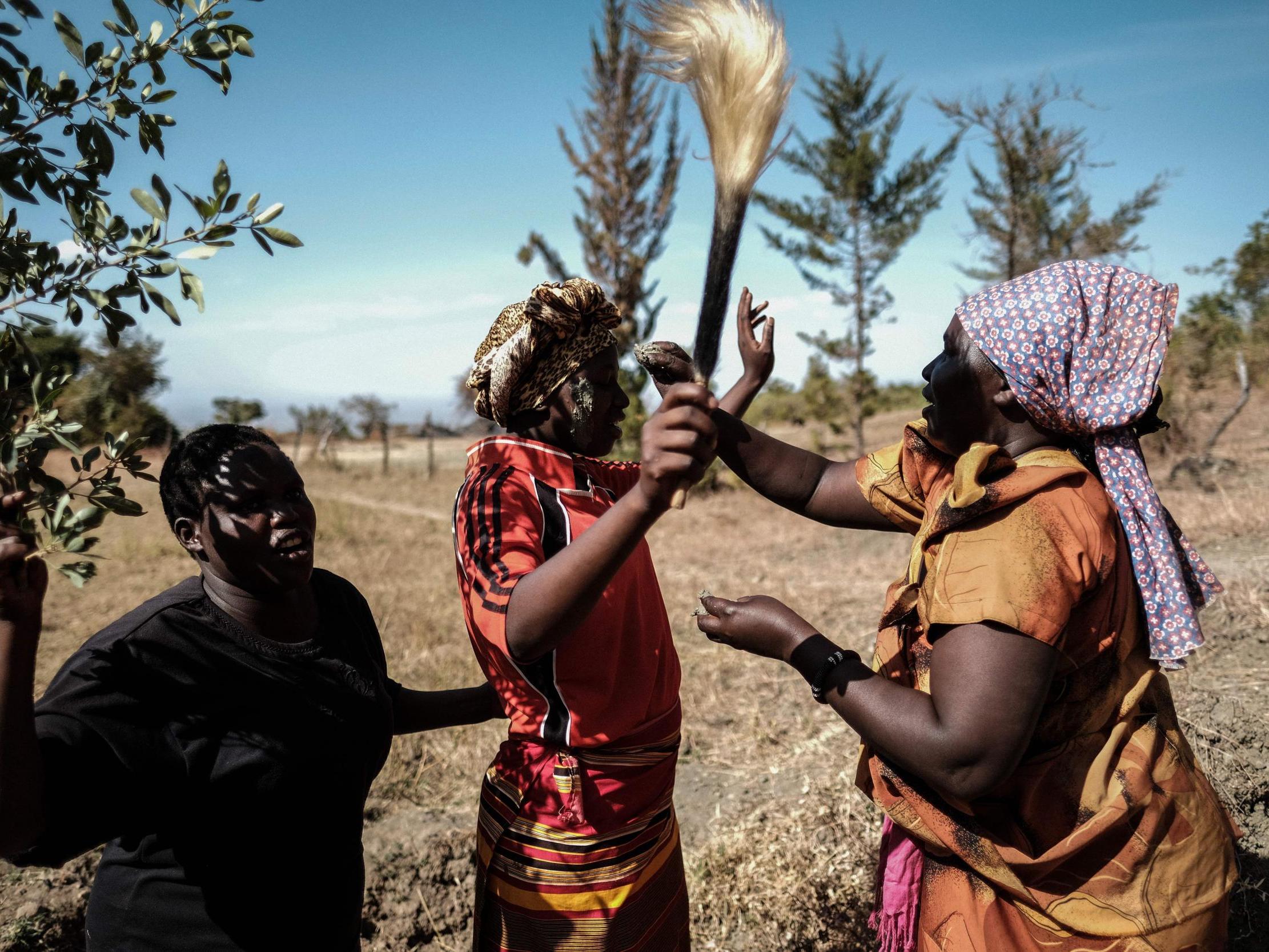 Women from the Pokot tribe reproduce a part of a circumcision ceremony at their initiation site in Chelel village, northeast Uganda, in 2018 – FGM has been banned there since 2010 (AFP/Getty )