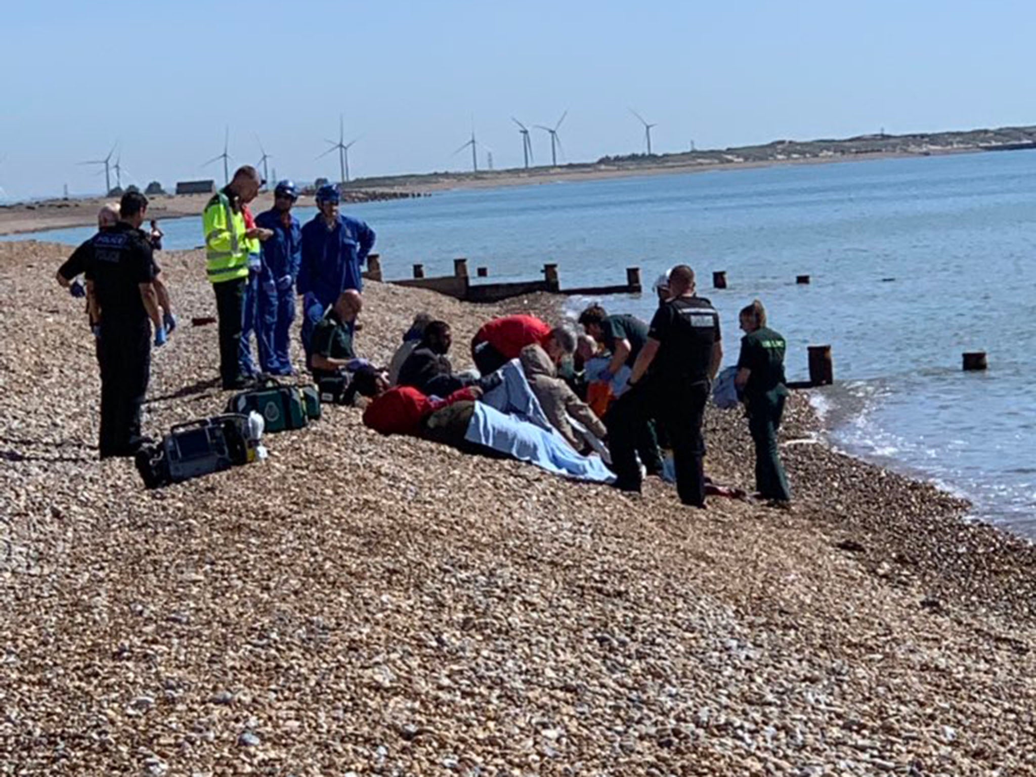 Eight men were seen on Winchelsea Beach after apparently crossing the Channel (Sean Winchelsea/ Twitter)