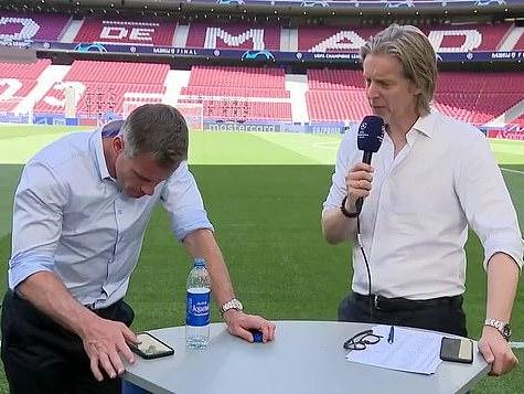 Jamie Carragher is caught on his phone during a live broadcast