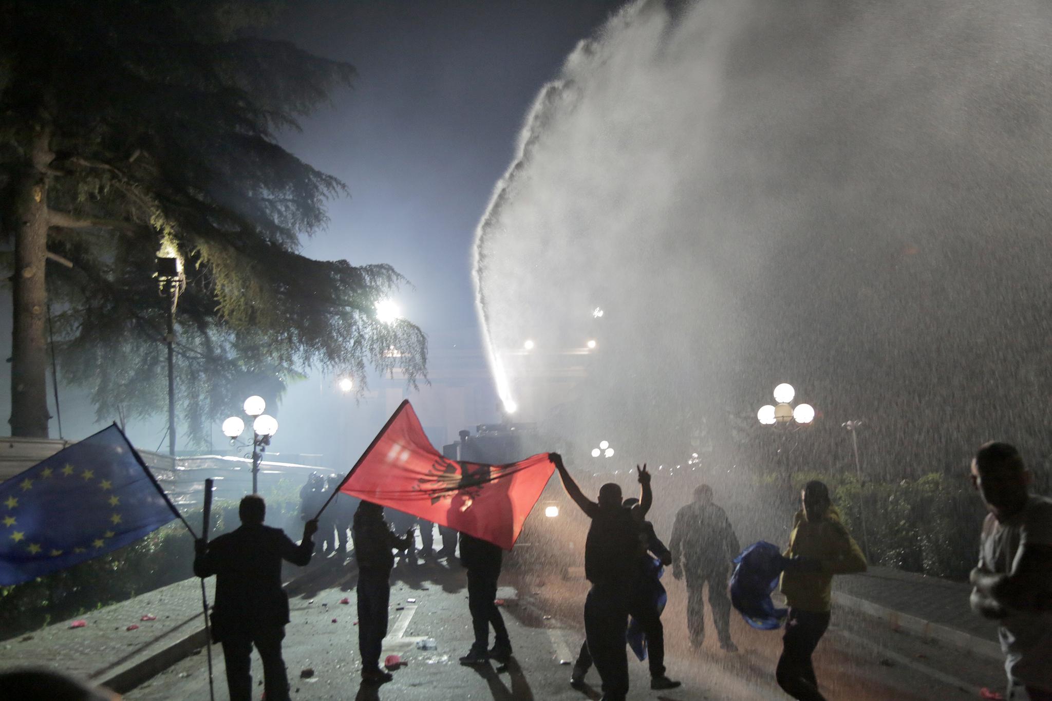 Ten police officers and at least three other people were injured in the confrontation which saw the police using tear gas and water cannons to disperse a group of protesters who were advancing towards the parliament.
