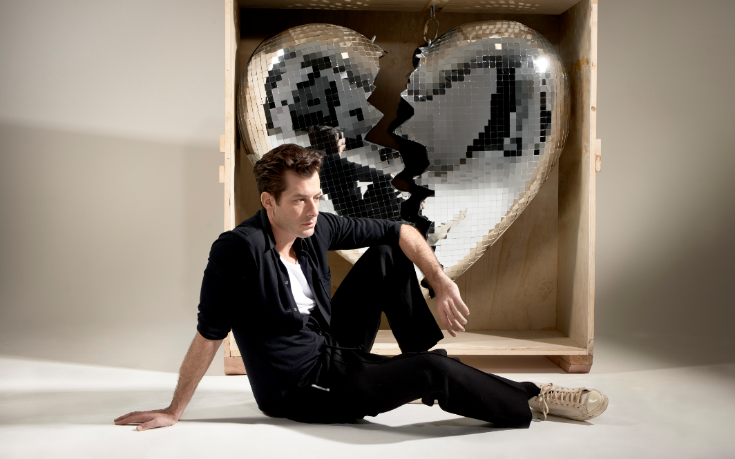 Ronson’s latest album logo, a disco ball in the shape of a broken heart, is also inked on his bicep