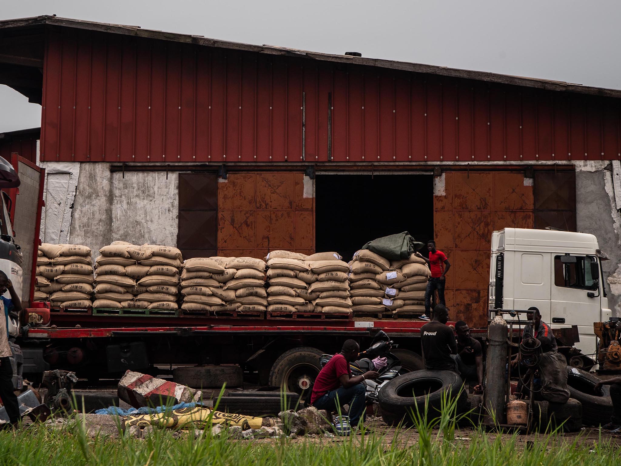 Men unload bags of cocoa near the office of Cargill, one of the leading cocoa suppliers for the chocolate industry