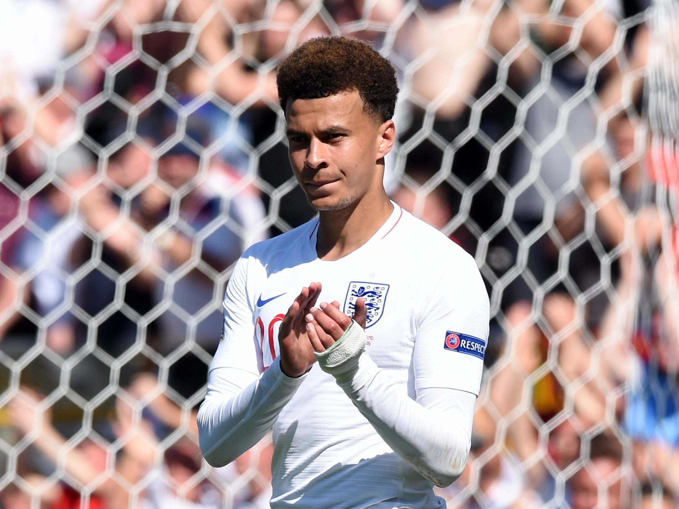 Dele Alli applauds England’s travelling fans after the game