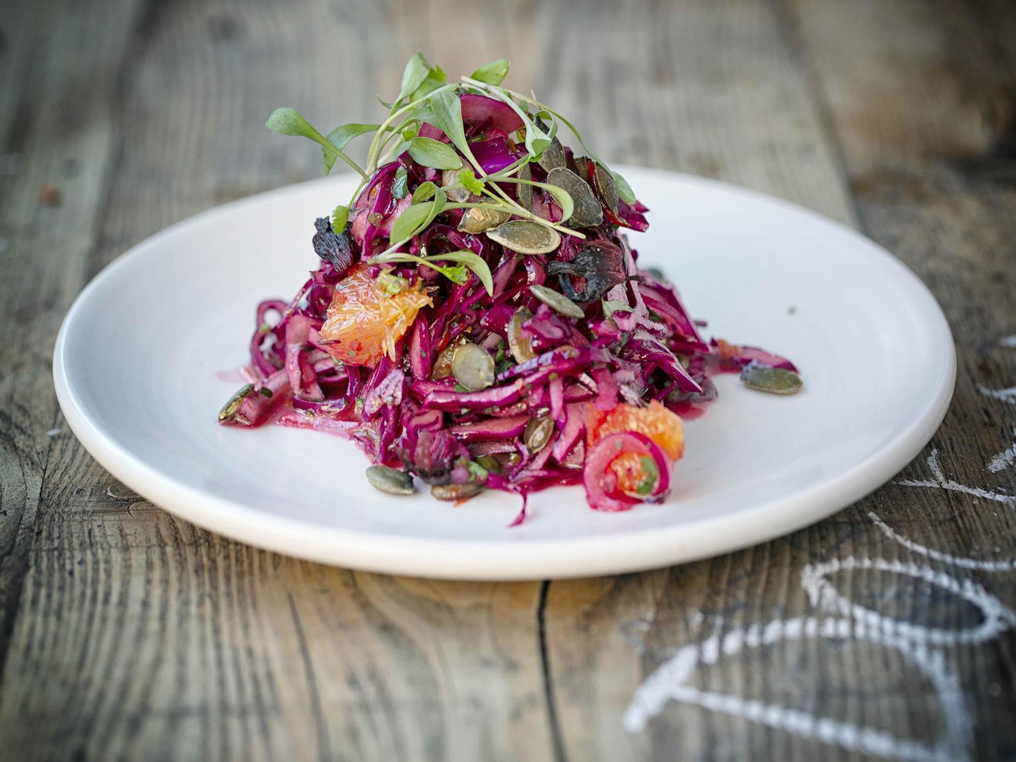 Sweet and savoury: pink hibiscus with orange and pumpkin seeds