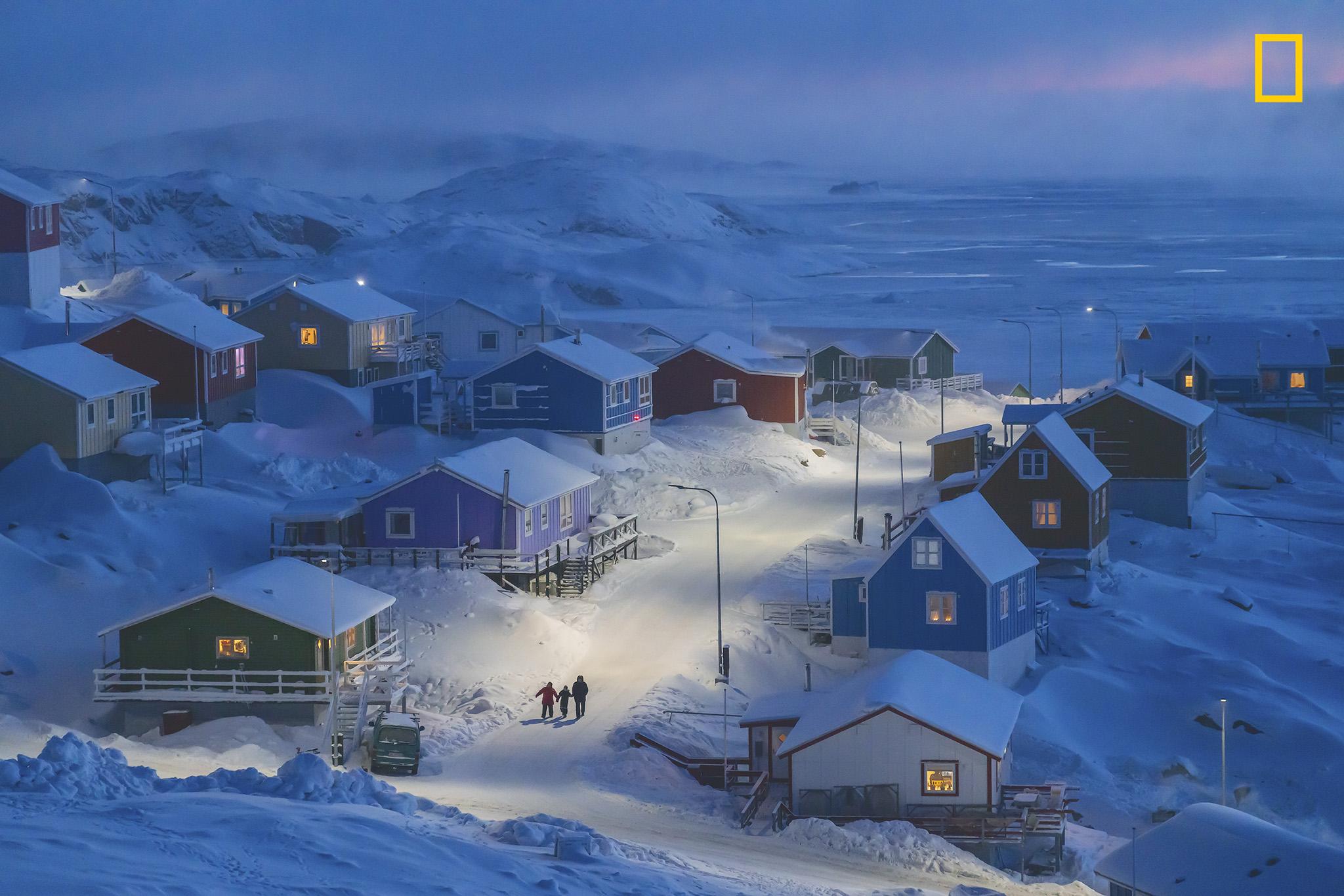 "Upernavik is a fishing village on a tiny island in west Greenland. Historically, Greenlandic buildings were painted different colors to indicate different functions, from red storefronts to blue fishermen’s homes—a useful distinction when the landscape is blanketed in snow. This photo was taken during my three-month, personal photo project to present life in Greenland."