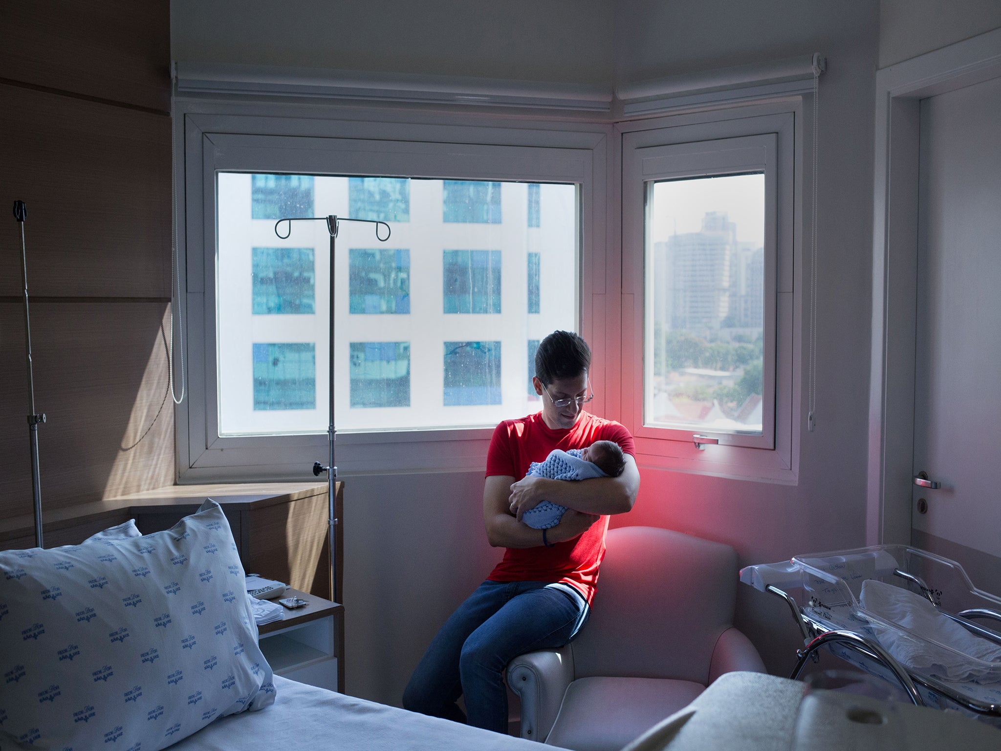 Fernando Tagliarine holds his son Arthur, who was born the night before. (Petala Lopes for The Washington Post)