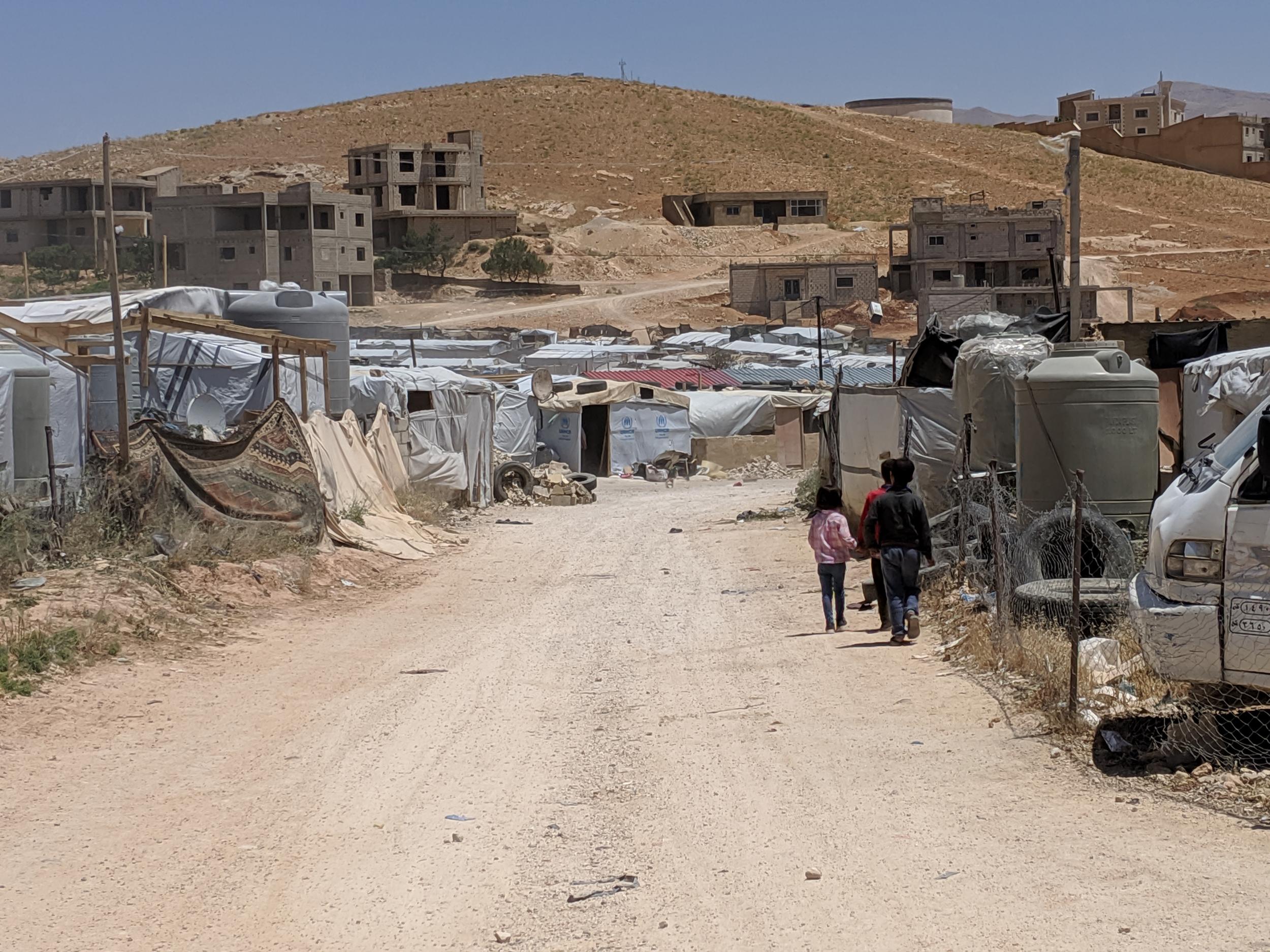 Children walk through the Al Ward informal refugee camp in Arsal (Richard Hall/ The Independent)