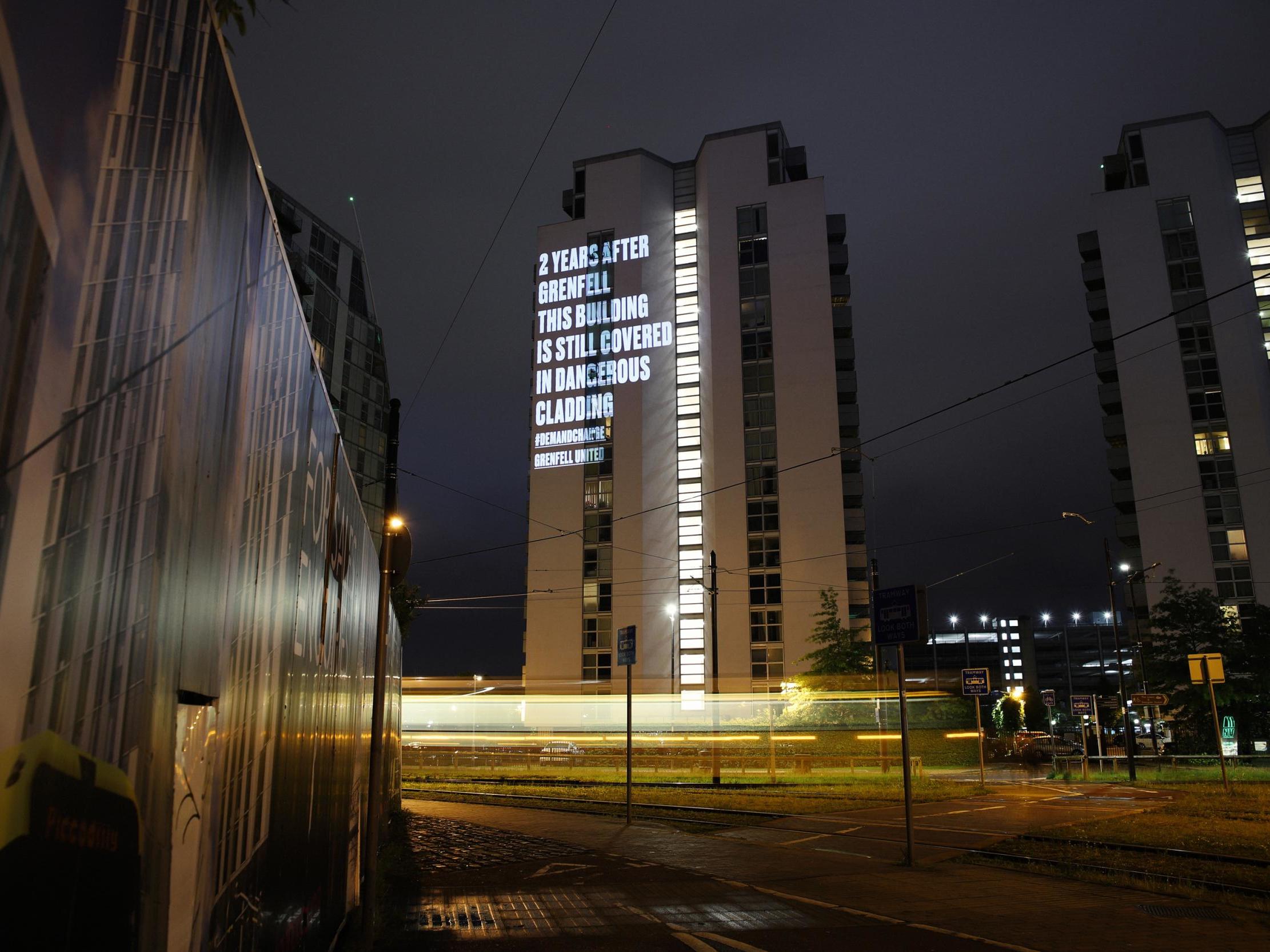 Grenfell United projected a message on to ​one of the NV Buildings in Salford