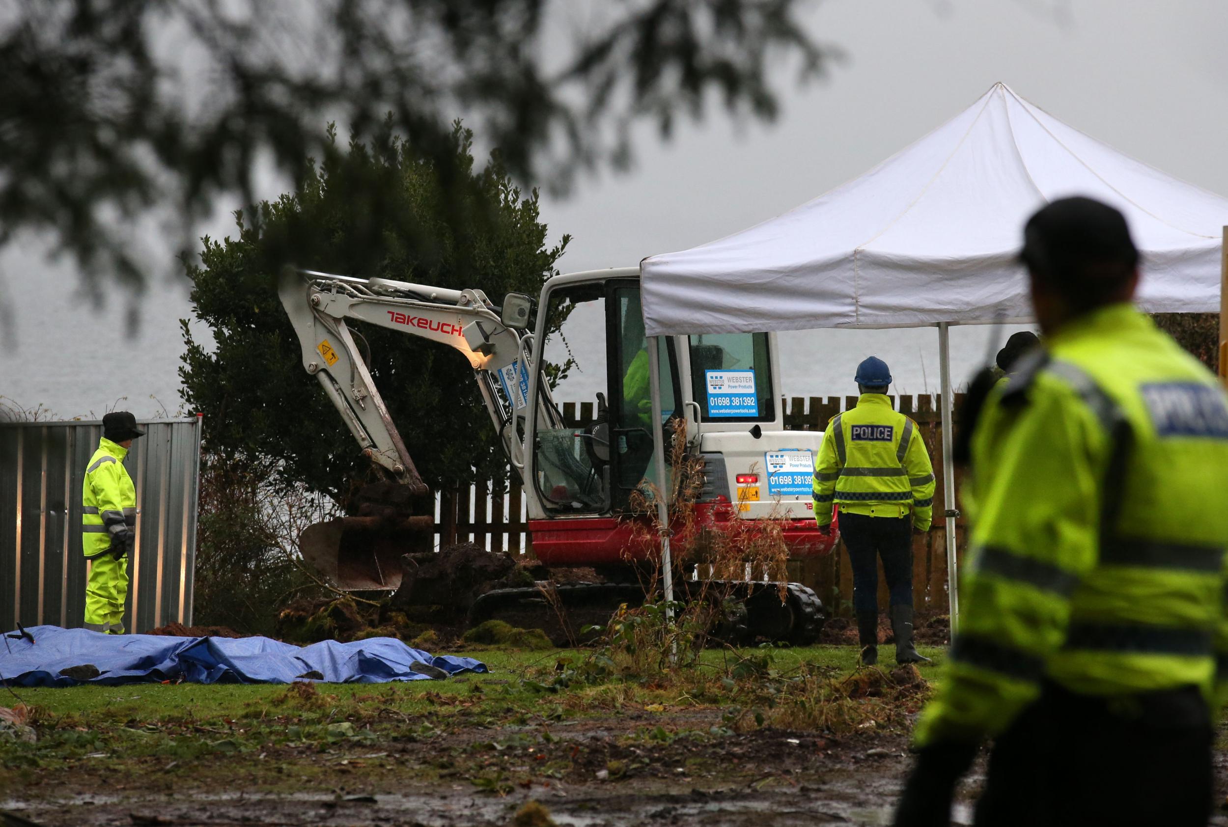 Police search a cottage and its grounds where Margaret Fleming lived in Inverkip, as they investigate the disappearance of the vulnerable woman last seen in public 17 years ago (PA)