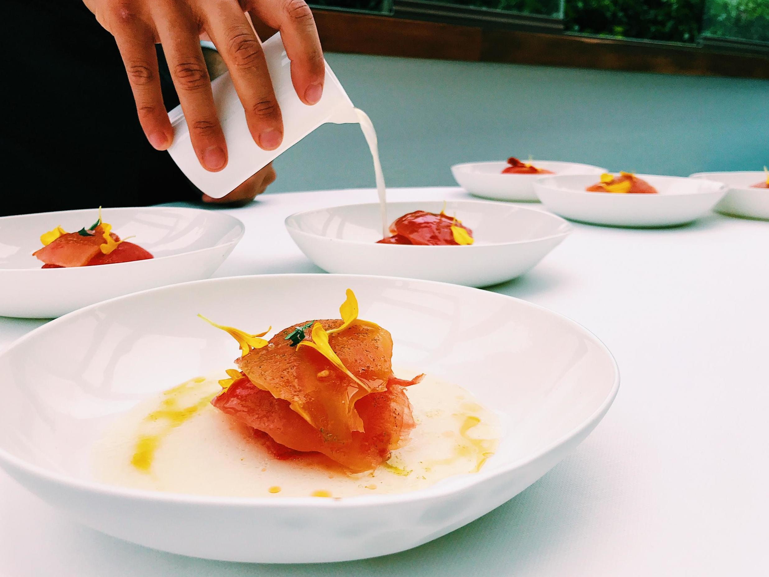 Chef Enzo di Pasquale pours caciotta broth on to beefsteak tomatoes