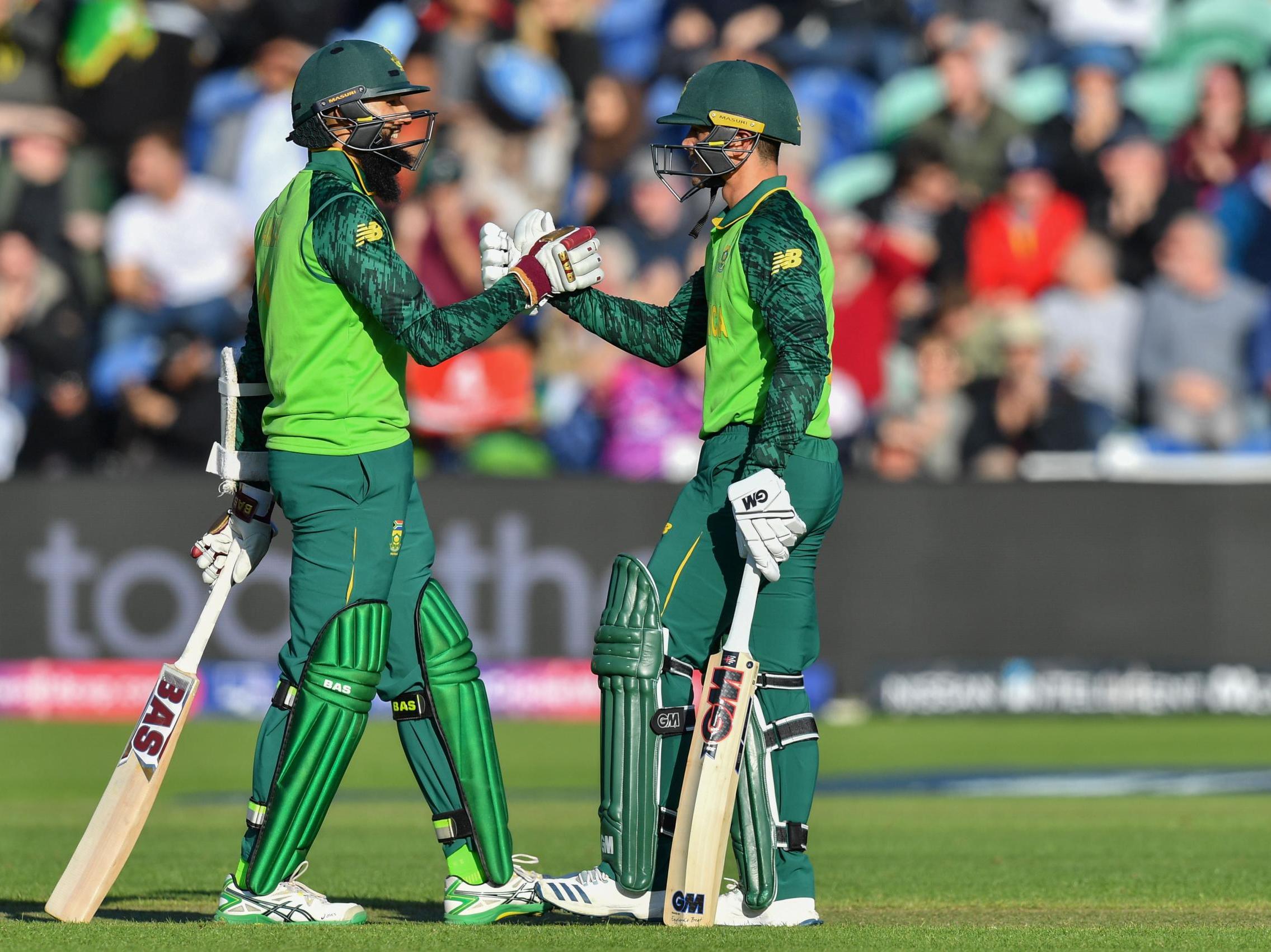 Quinton de Kock celebrates with teammate Hashim Amla after scoring a half-century