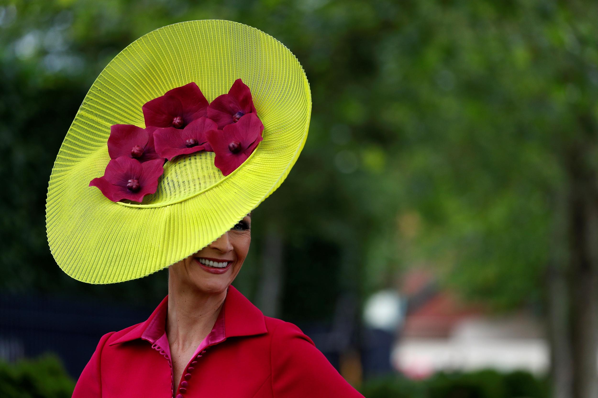 A racegoer poses for a photograph as she arrives on day one of the Royal Ascot horse racing meet, in Ascot, west of London, on June 18, 2019.