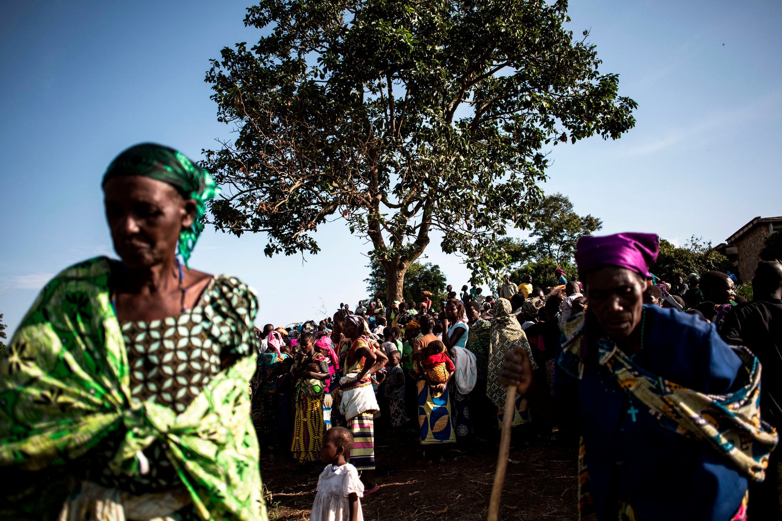 Congolese families wait inside a Internally Displaced Persons Camp as hundreds of thousands of people flee inter-ethnic violence in northeastern areas of the country