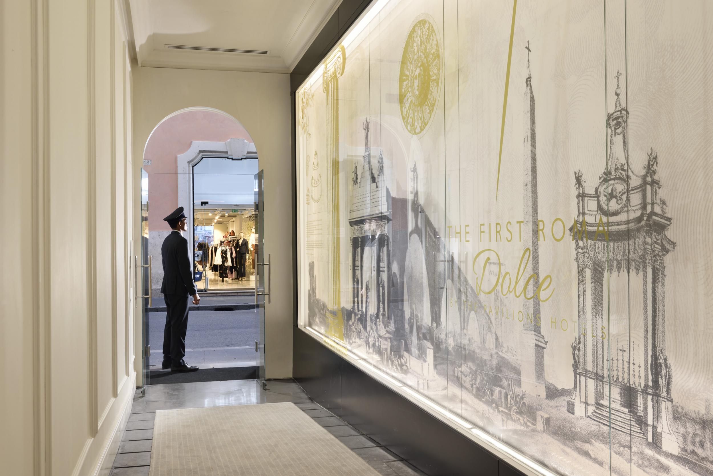 A doorman stands ready to greet guests