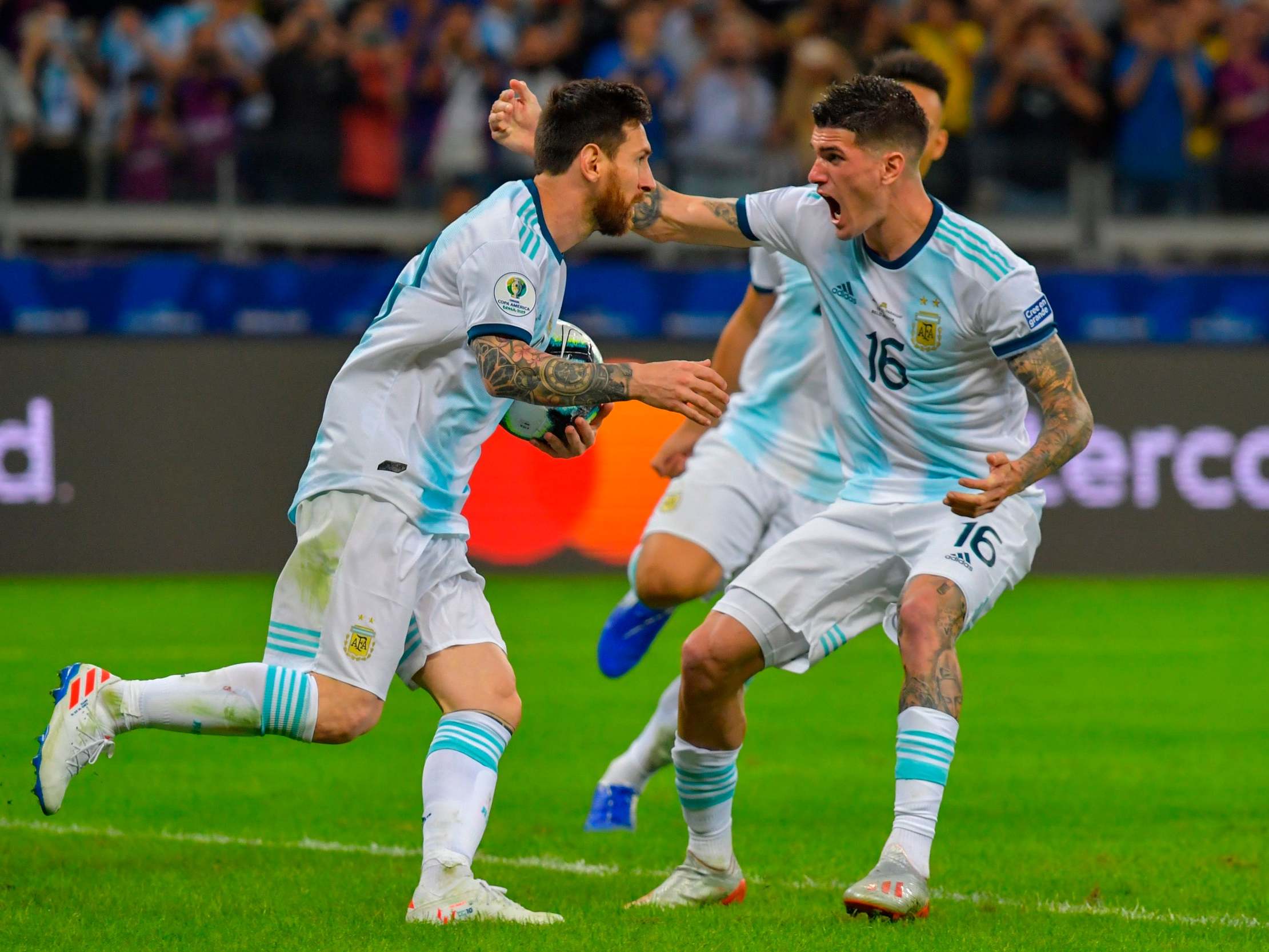 Messi is congratulated after scoring from the spot