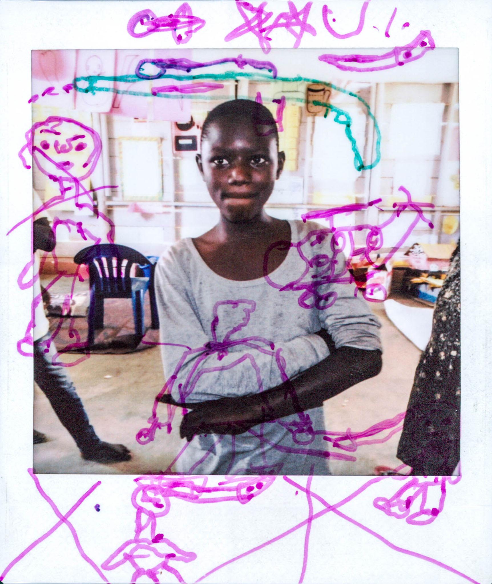 Prisca lives with his family in the camp. His father was killed by rebels back in the Congo. On his first picture Prisca's drawing represent the violence that he saw in the Congo, he says: "We have been in Uganda for one year now.Our life in Congo was really hard, the rebels came into our village, and raided our homes and took everything and beat up everyone. And one day my father was taken from our house by the rebels and killed, so we decided to run for our lives. I have a very strong memory of the day he was killed. He pleaded for his life in vain. In the future I just want to live a normal life, get a job and live peacefully."