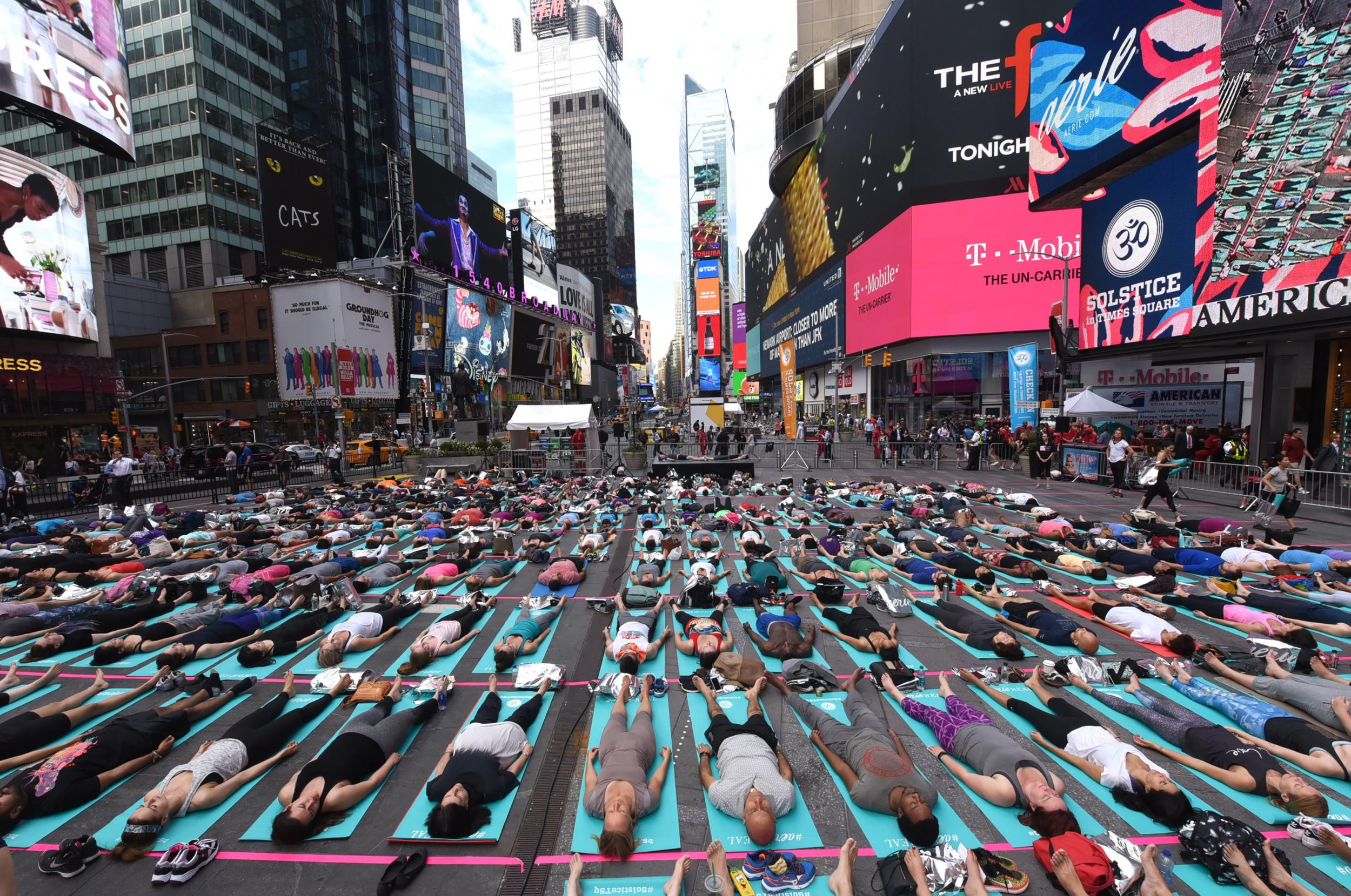 Each year, hundreds of people take part in a yoga class in Times Square to celebrate the summer solstice