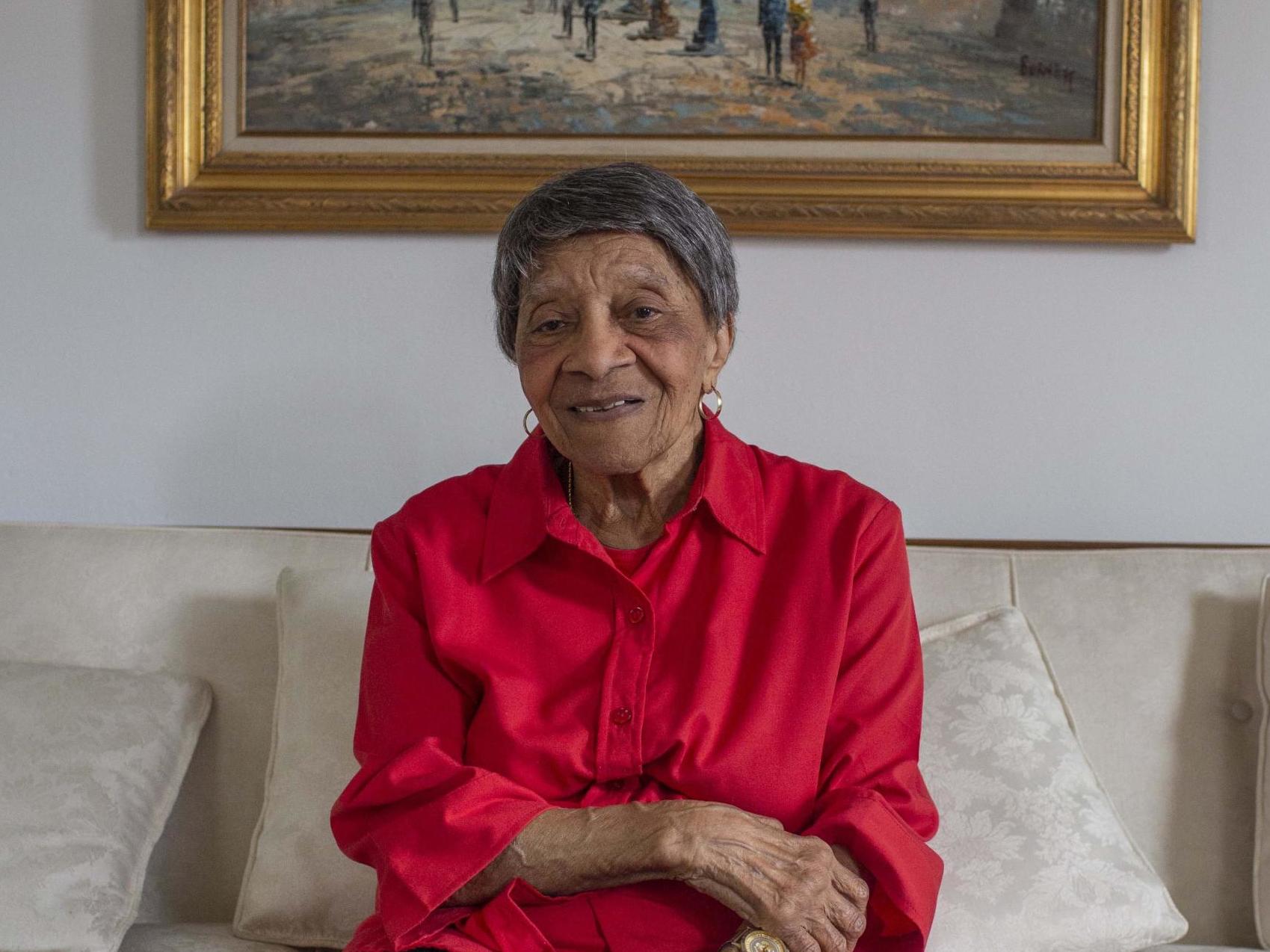 Louise Griffin and her White House Volunteer of the Week placard at home in Washington, D.C.