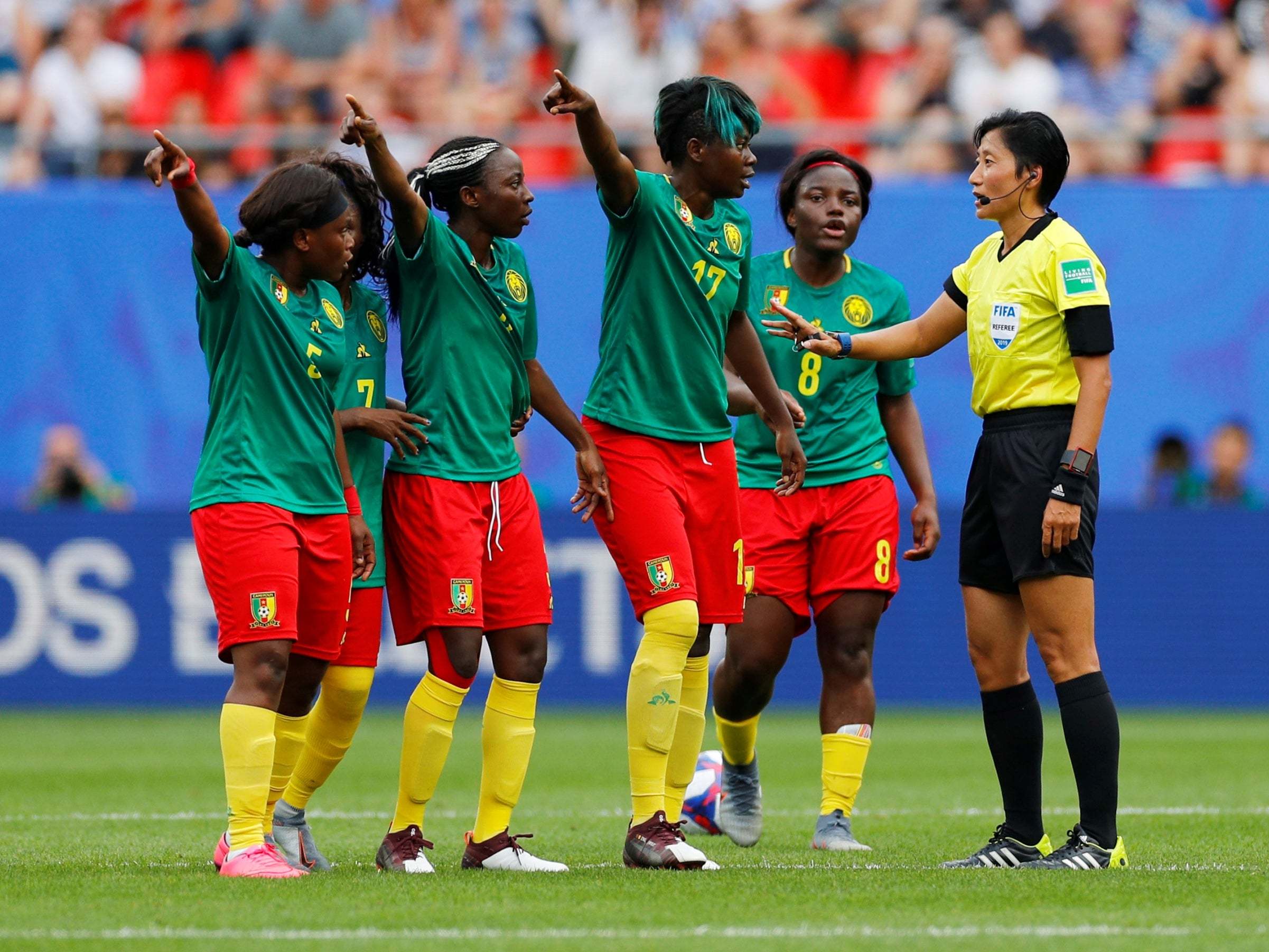 Cameroon players remonstrate with the referee (Reuters)