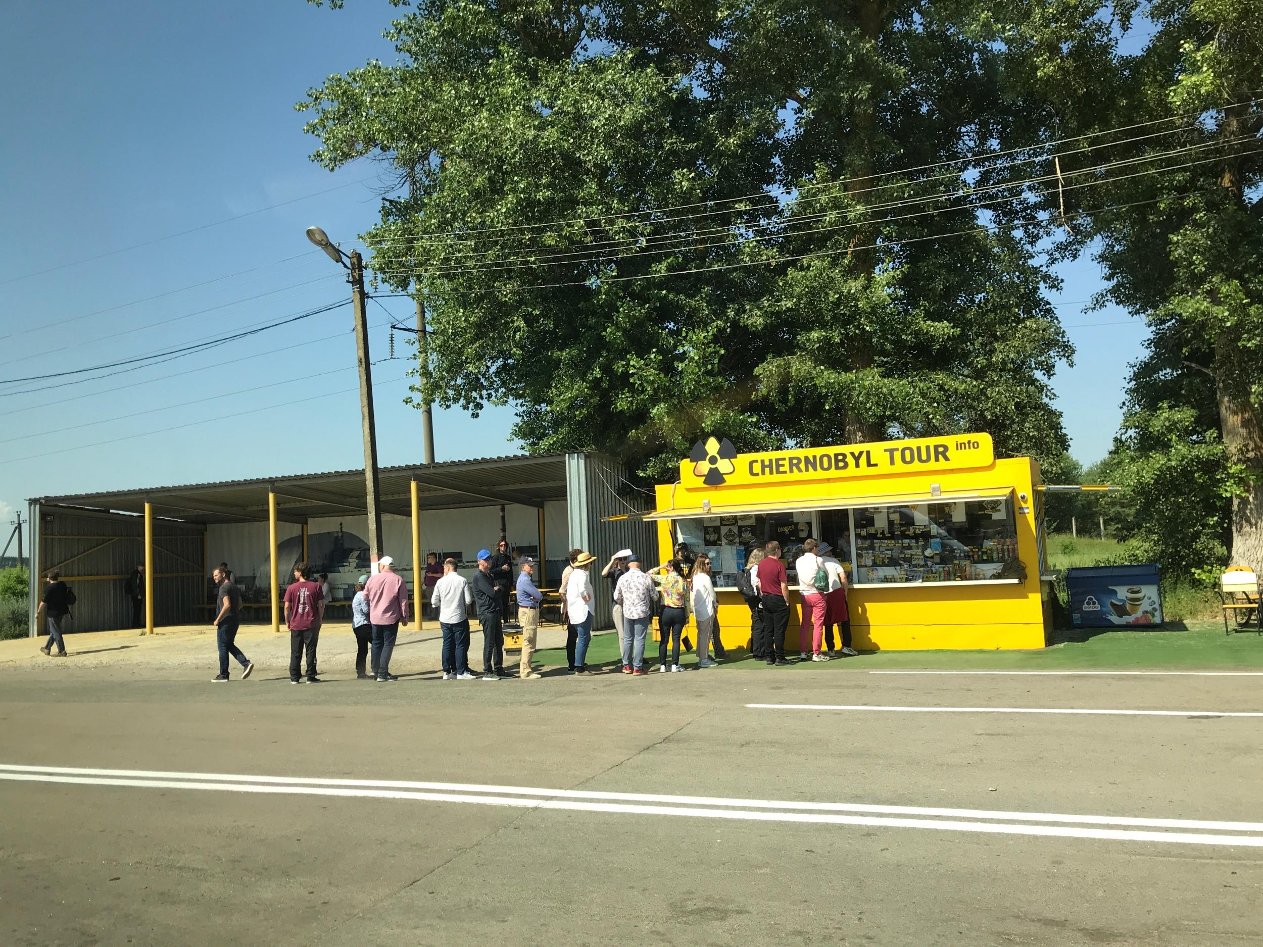 Tourists line up to buy memorabilia from the Chernobyl Tour company, just outside the first checkpoint at the entrance to the Exclusion Zone