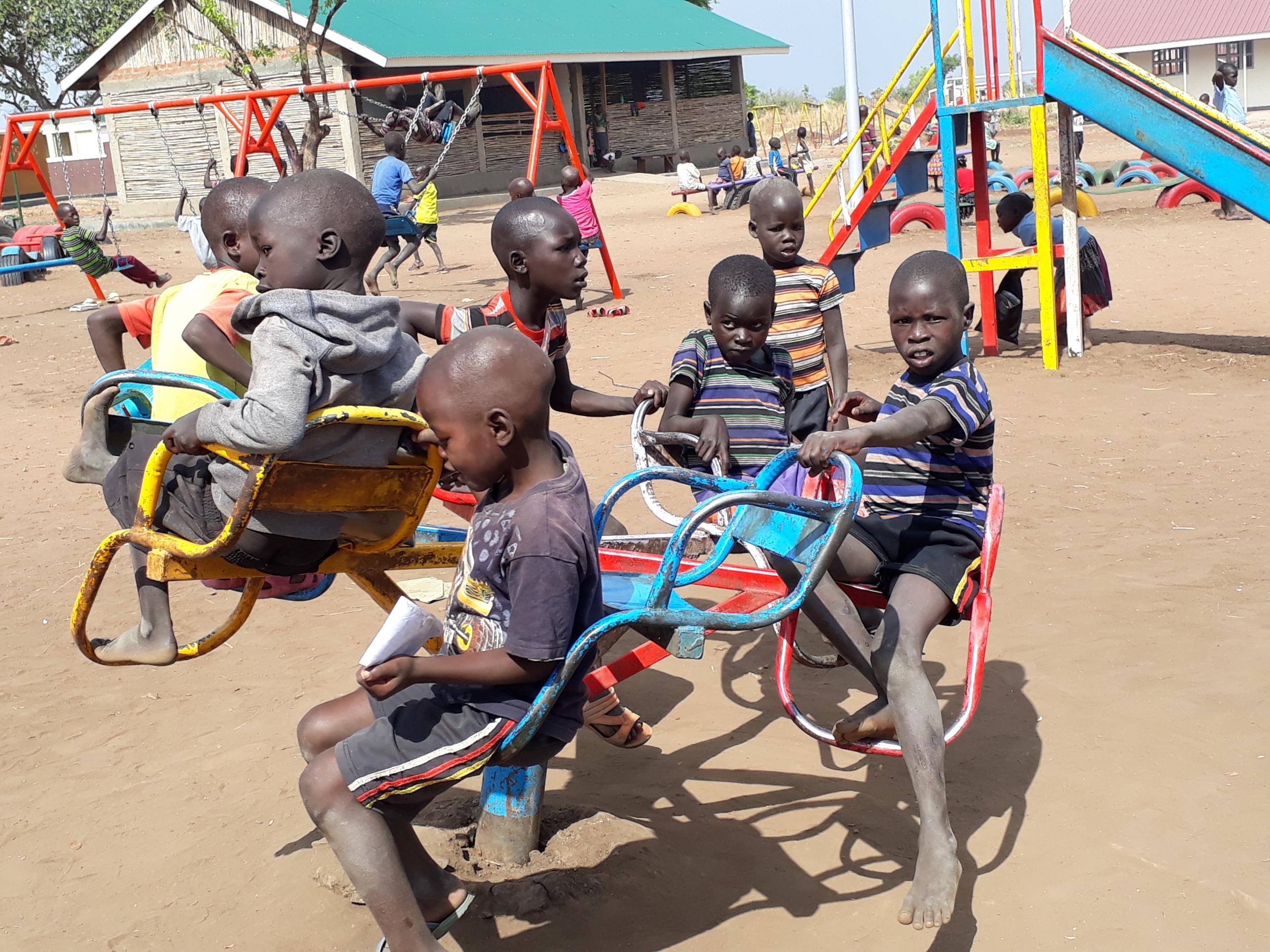 Refugee children and youngsters from host communities play at a park in Palabek Refugee settlement, during the mid-morning break. This facility is supported by Unicef with EU financial assistance – it also provides psychosocial support to refugee children as well as a place to play, learn, interact, sing and dance after all the traumatic experiences they may have gone through.