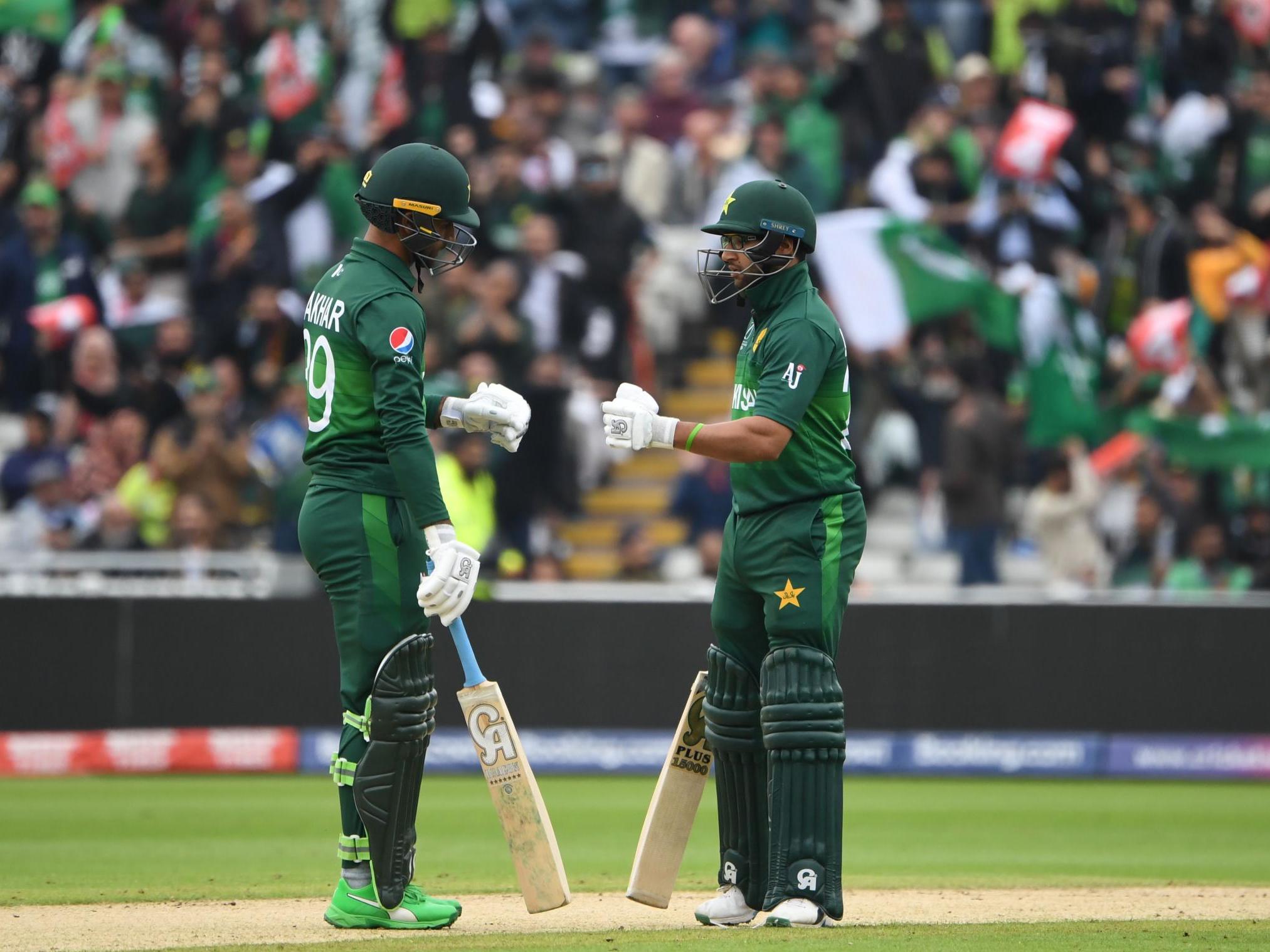 Imam-ul-Haq (R) and teammate Fakhar Zaman touch gloves after a boundary