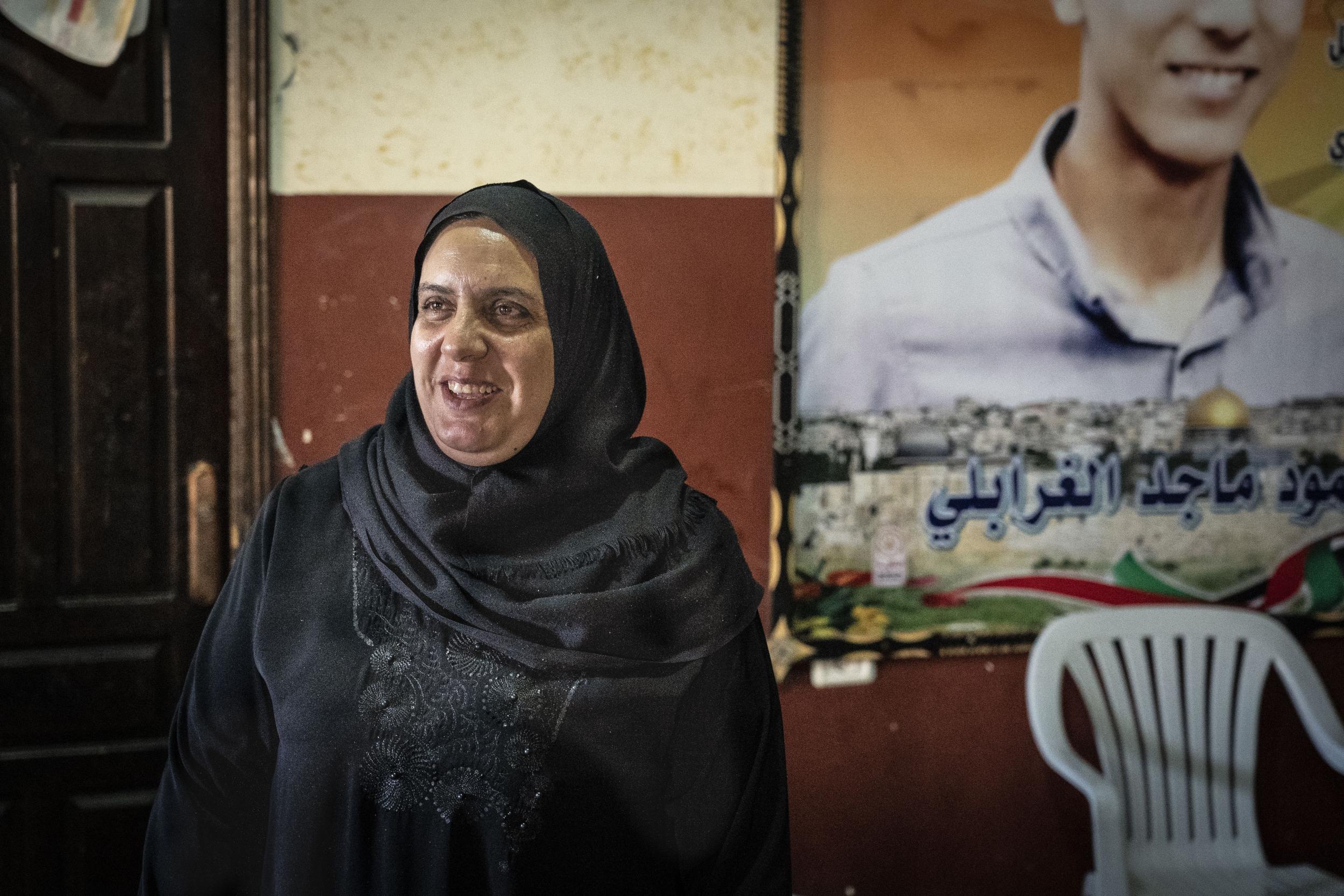 Ghaliah Gharabli, a mother-of four in Gaza, whose daughter was treated for trauma after her son (in the picture behind her) was killed near the border