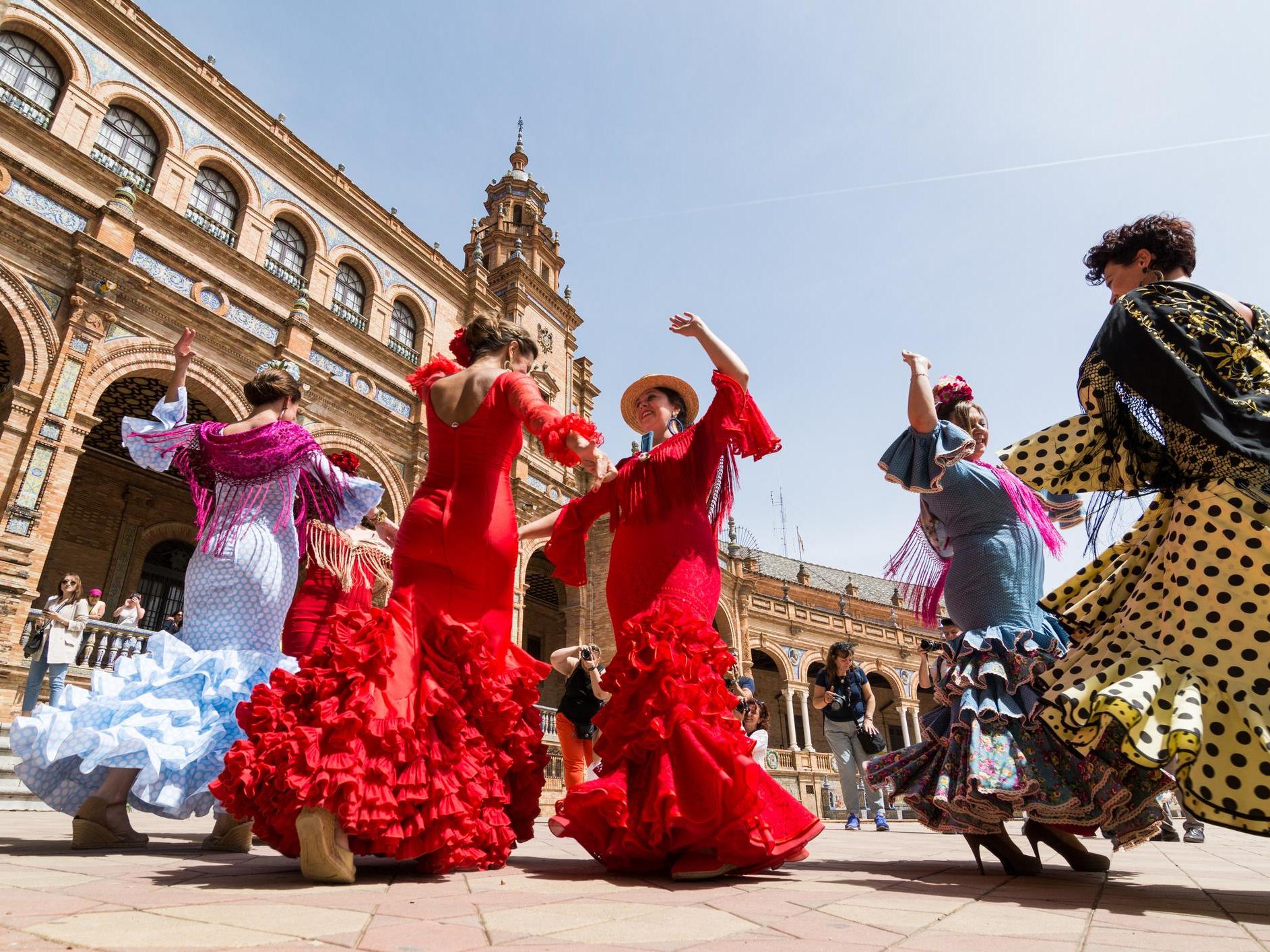 Young women dance flamenco on Plaza de Espana during famous Feria festival