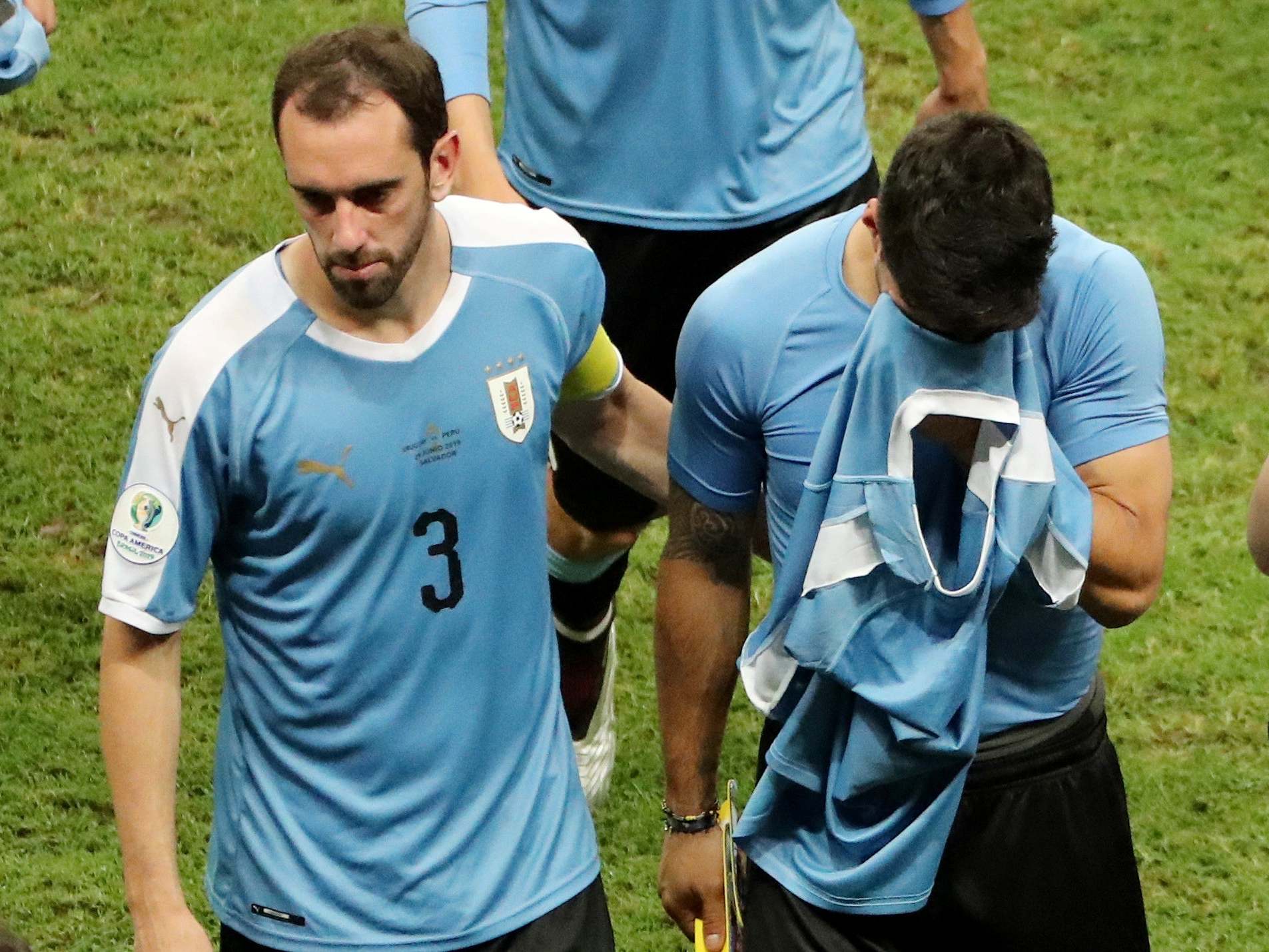 Diego Godin consoles Luis Suarez after his penalty miss