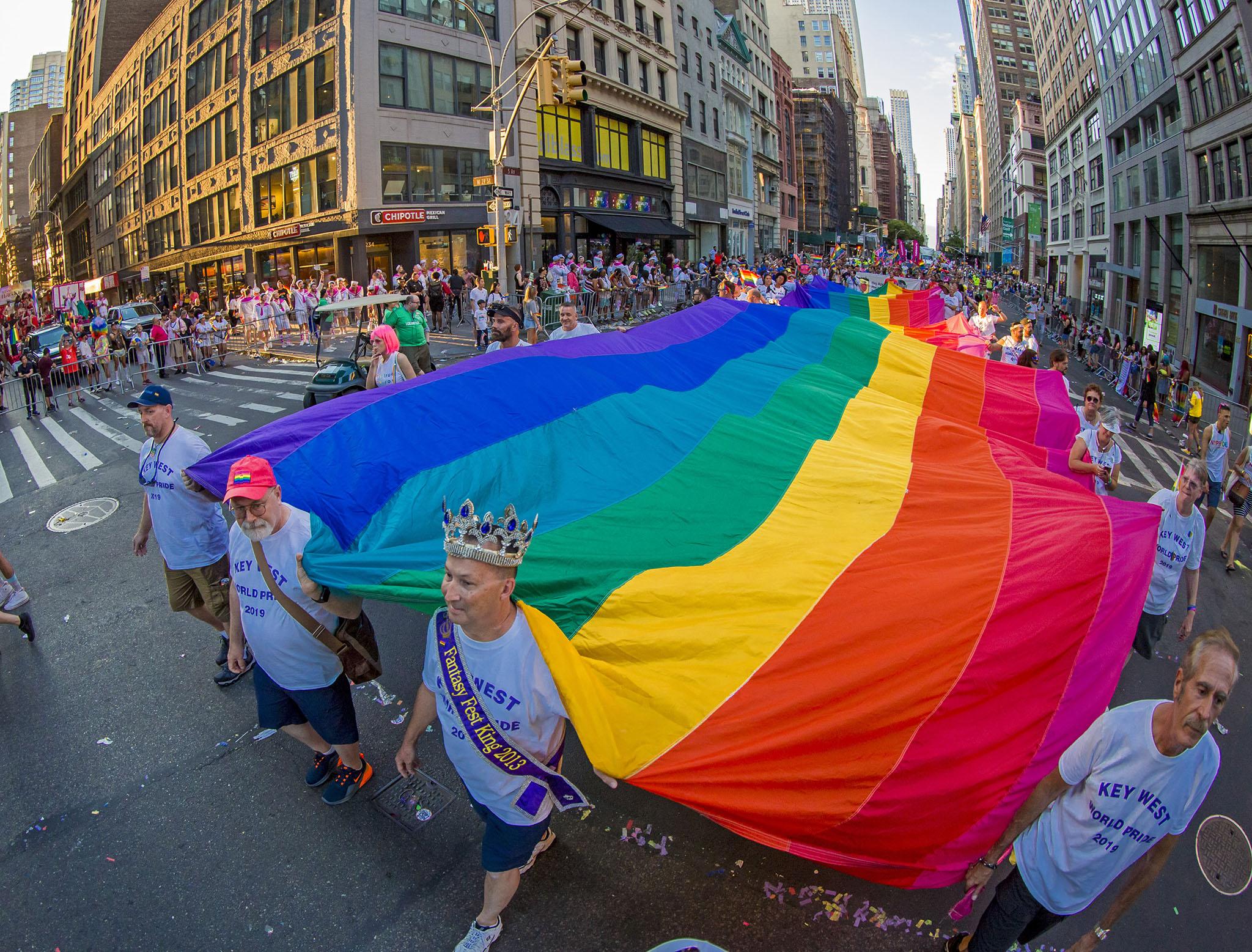 Representatives of Key West carry a 100-foot-long rainbow flag during the World Pride March in New York