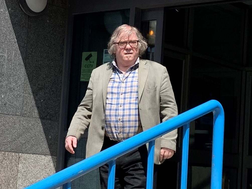 John Keogh, 74, leaves Croydon Magistrates Court in south London after he was fined £600 for committing a racially aggravated offence