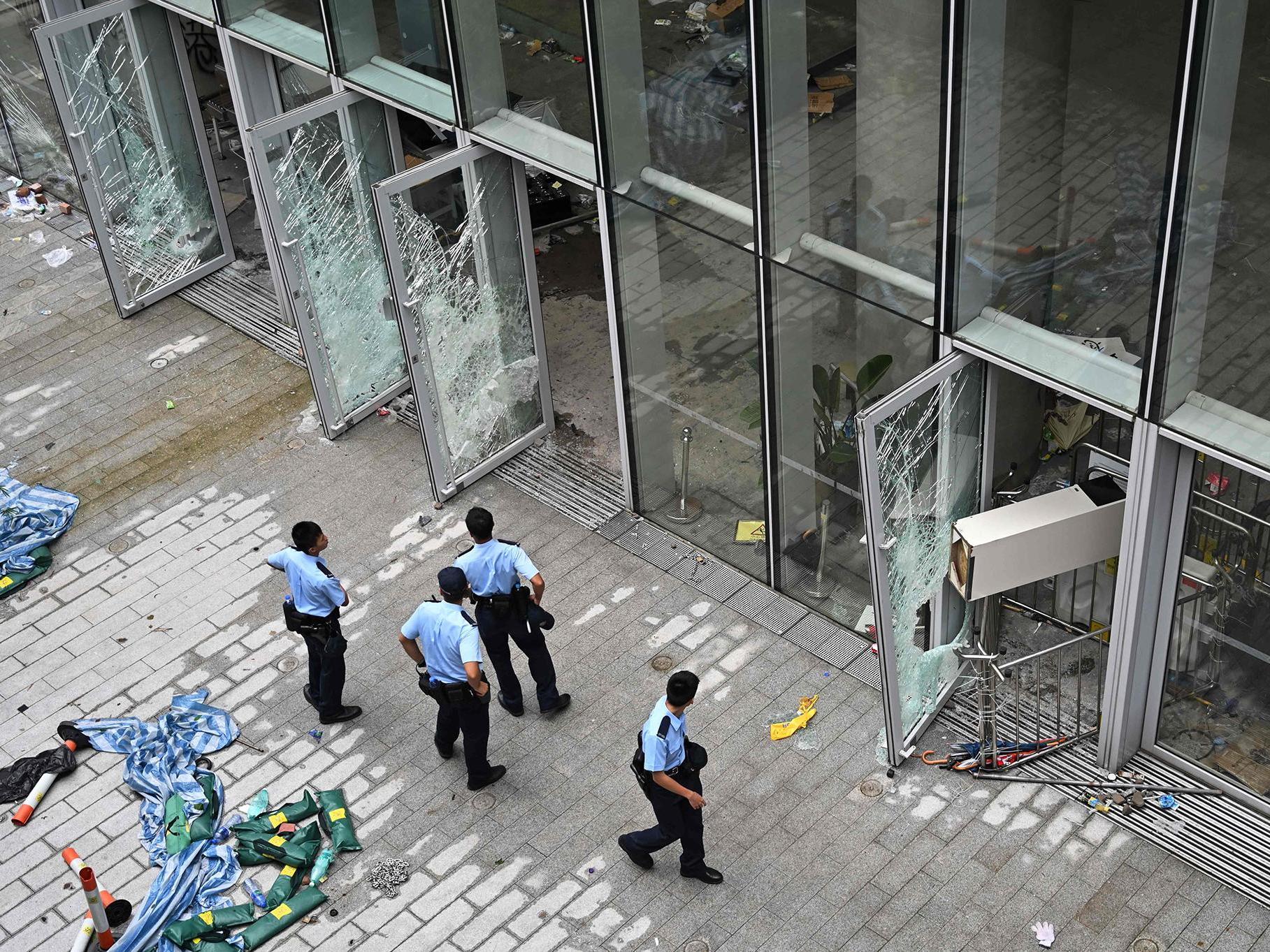 Police outside the legislative council building the day after protesters broke in