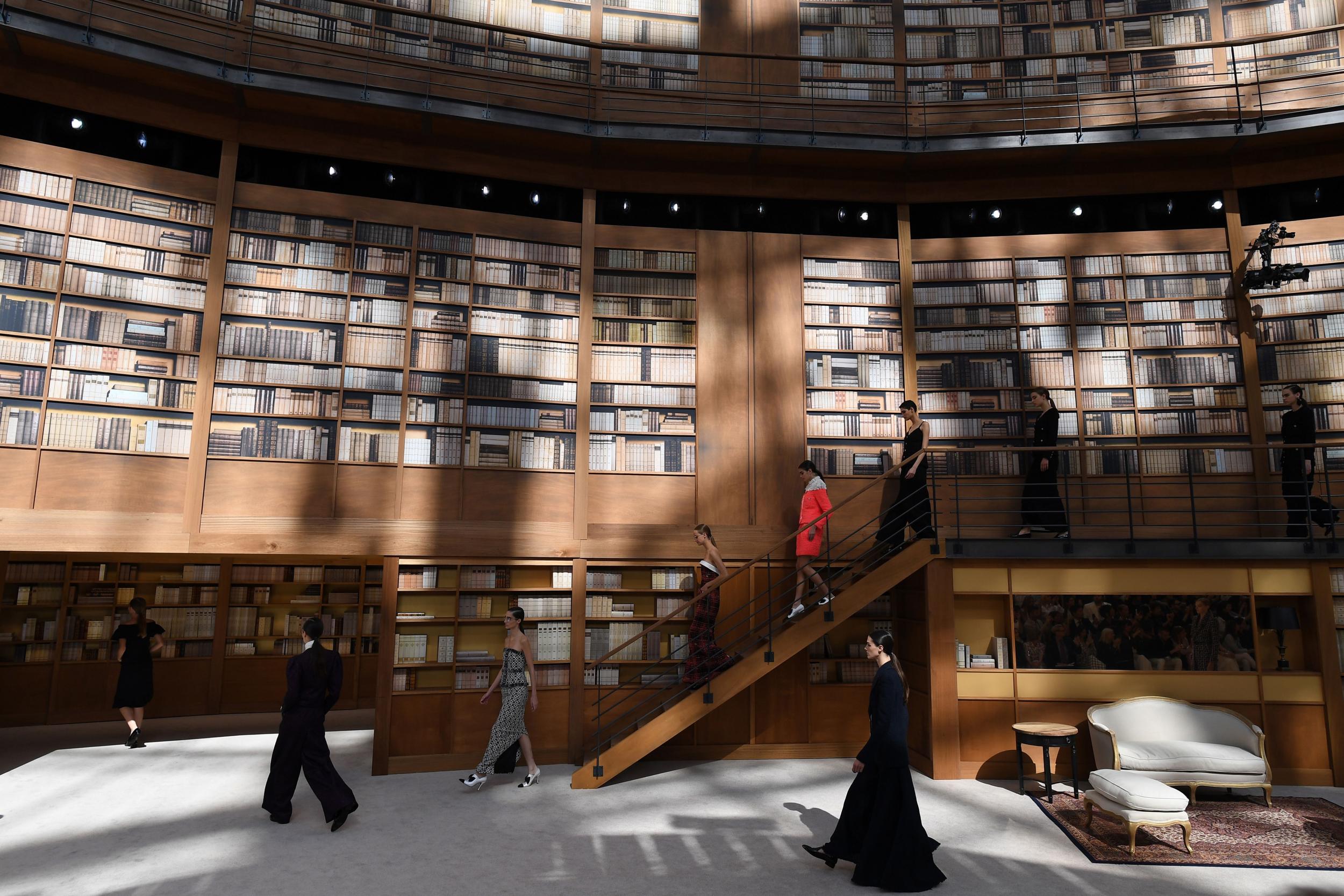 Models present creations by Chanel during the Women's Fall-Winter 2019/2020 Haute Couture collection fashion show at the Grand Palais turned into a giant library in Paris, on July 2, 2019