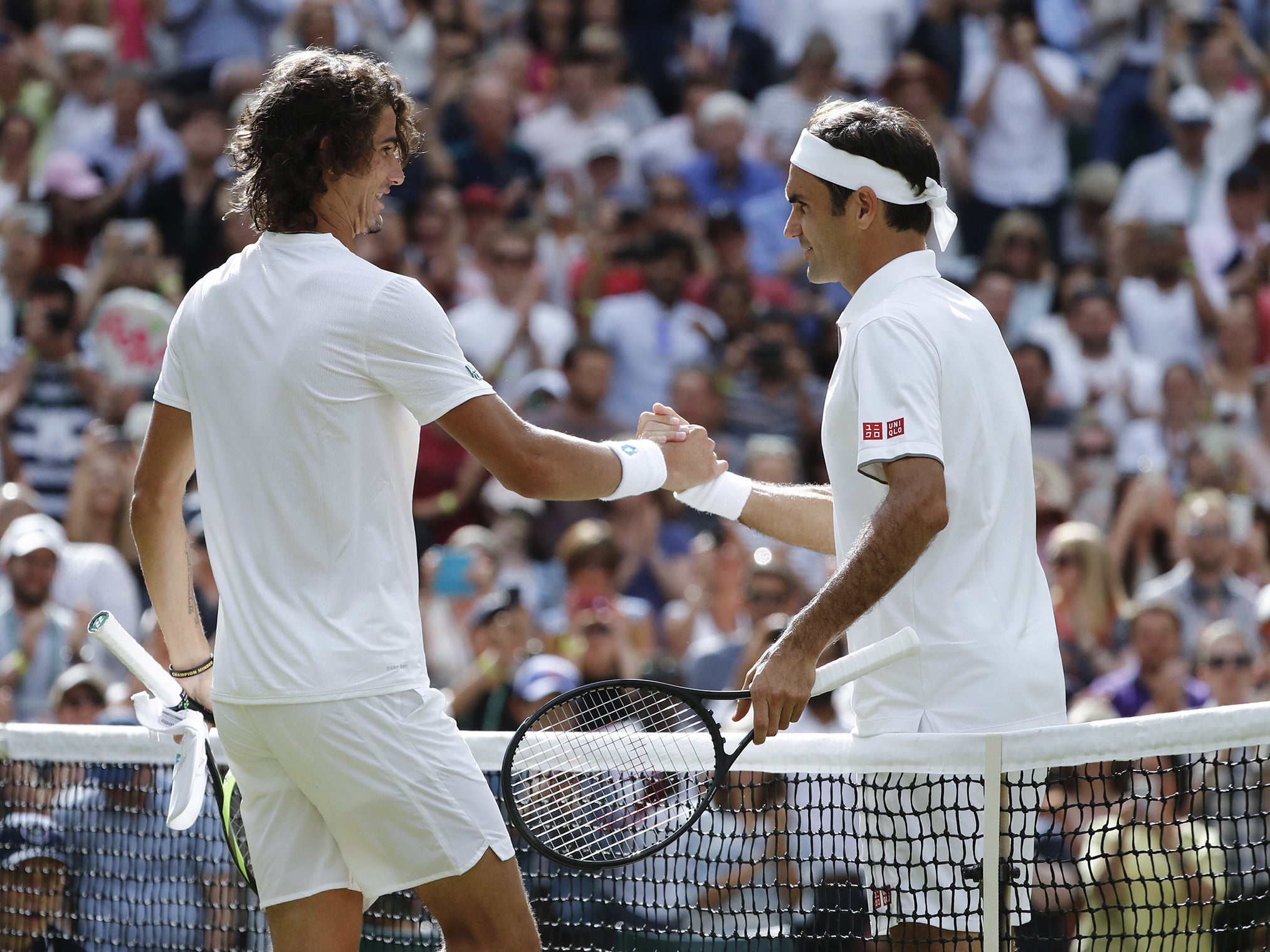 Harris and Federer shake hands at the net